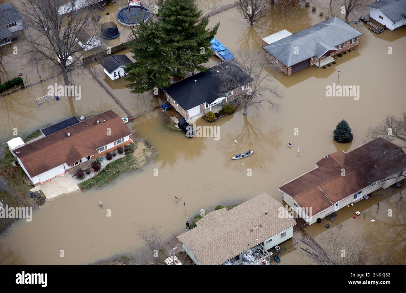 In this aerial photo, people use a canoe to navigate a flooded street