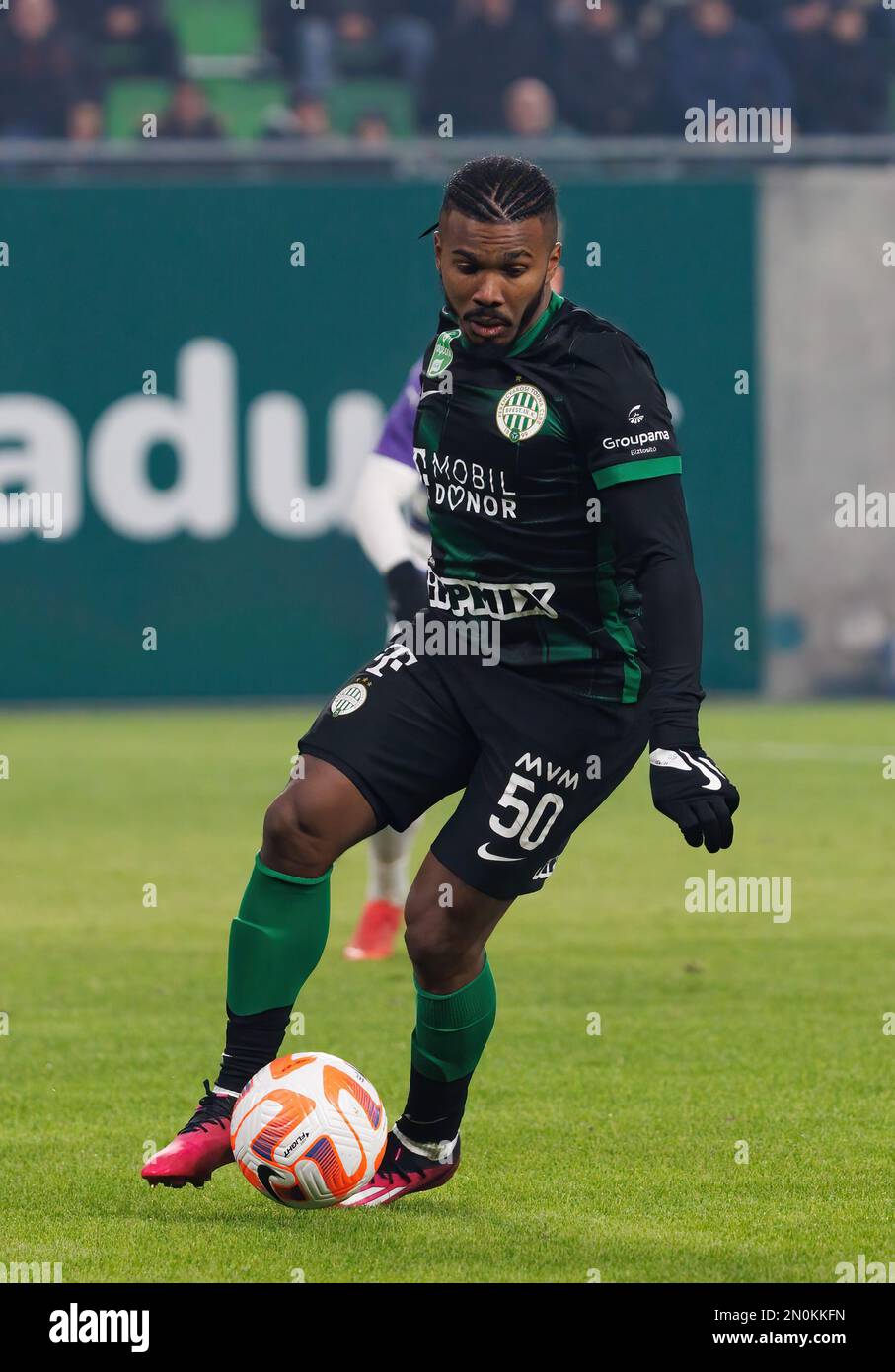 Anderson Esiti of Ferencvarosi TC challenges Luis Jakobi of Ujpest