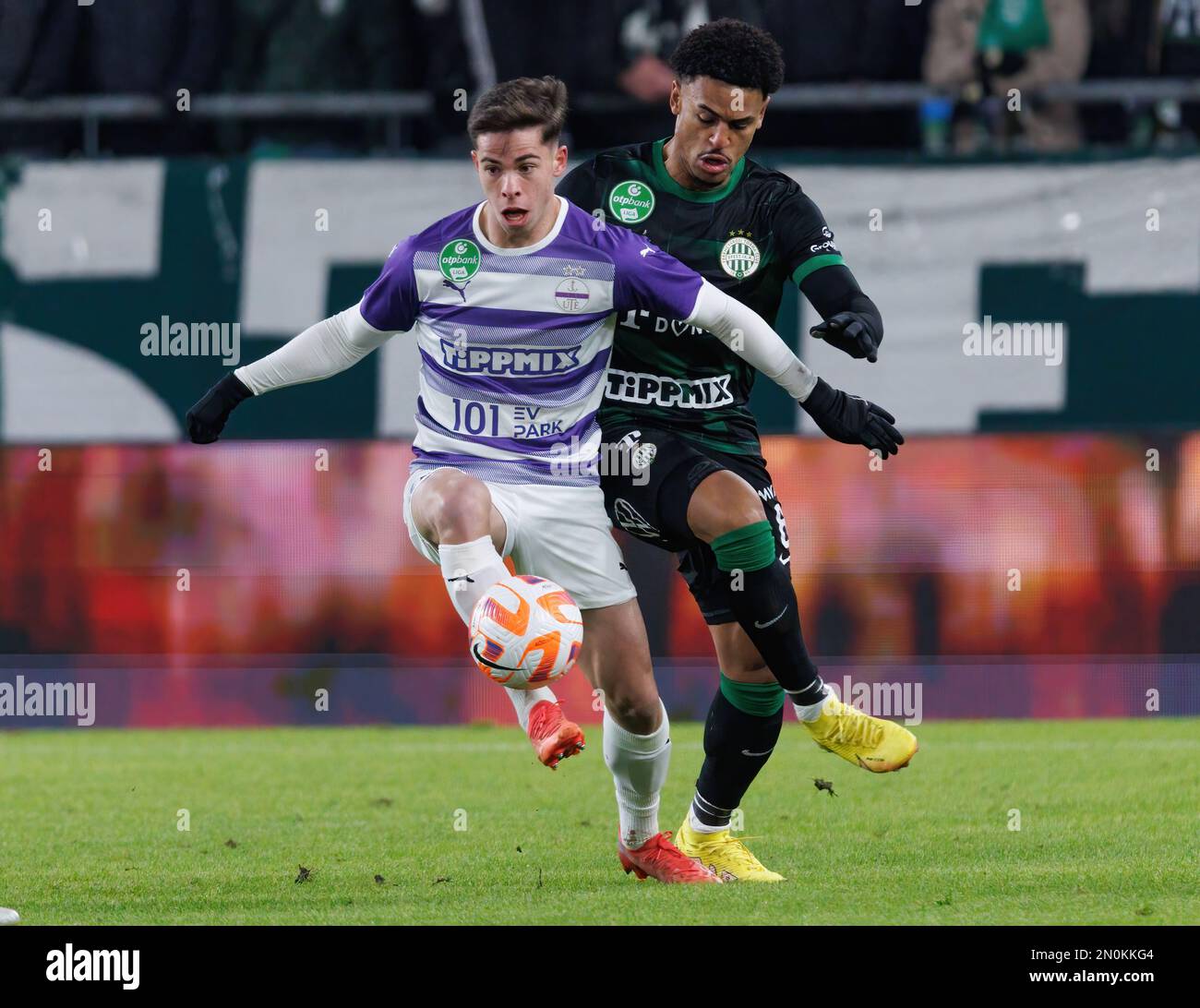 Anderson Esiti of Ferencvarosi TC challenges Luis Jakobi of Ujpest