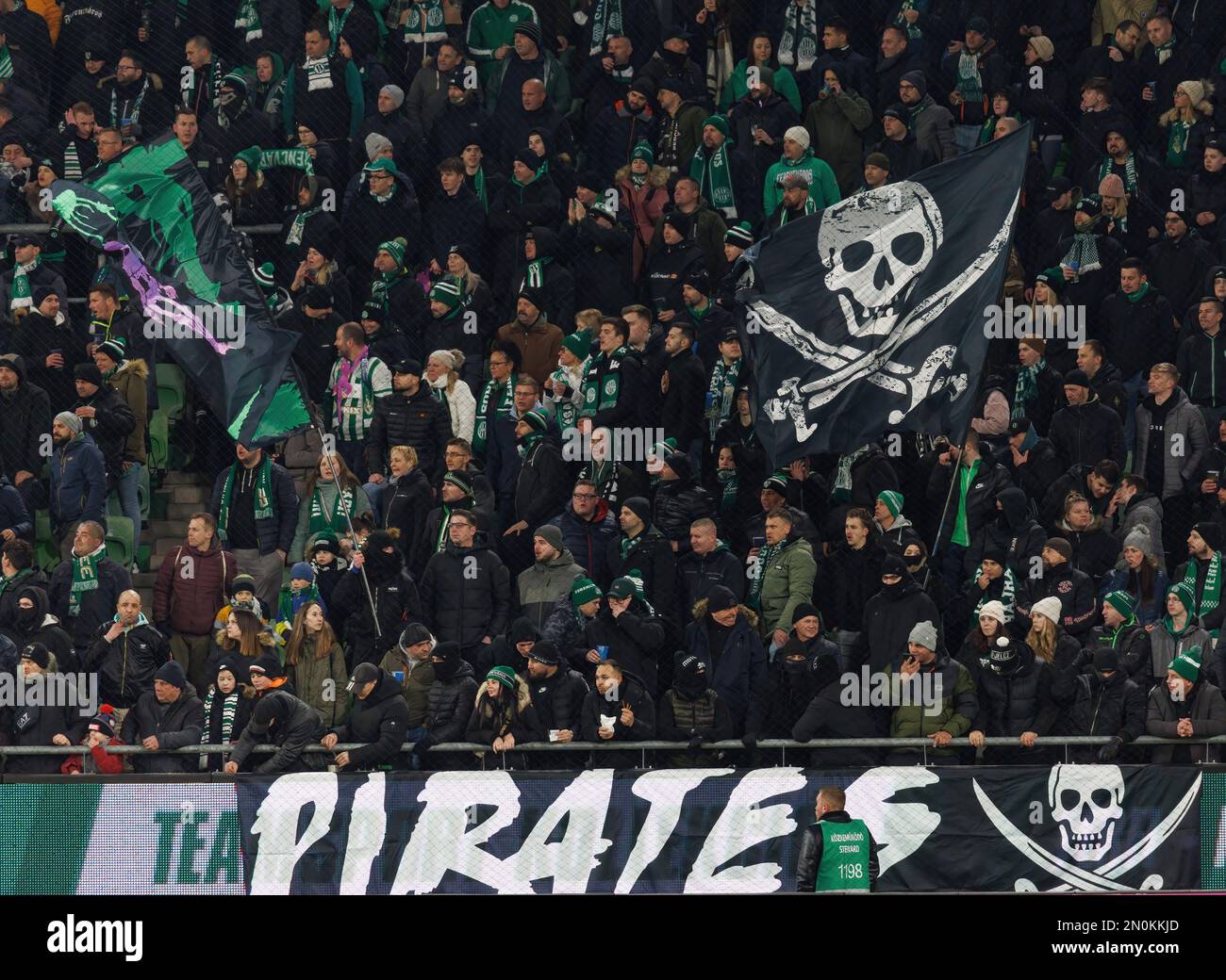 Ultra supporters of Ferencvarosi TC lift scarves over their heads