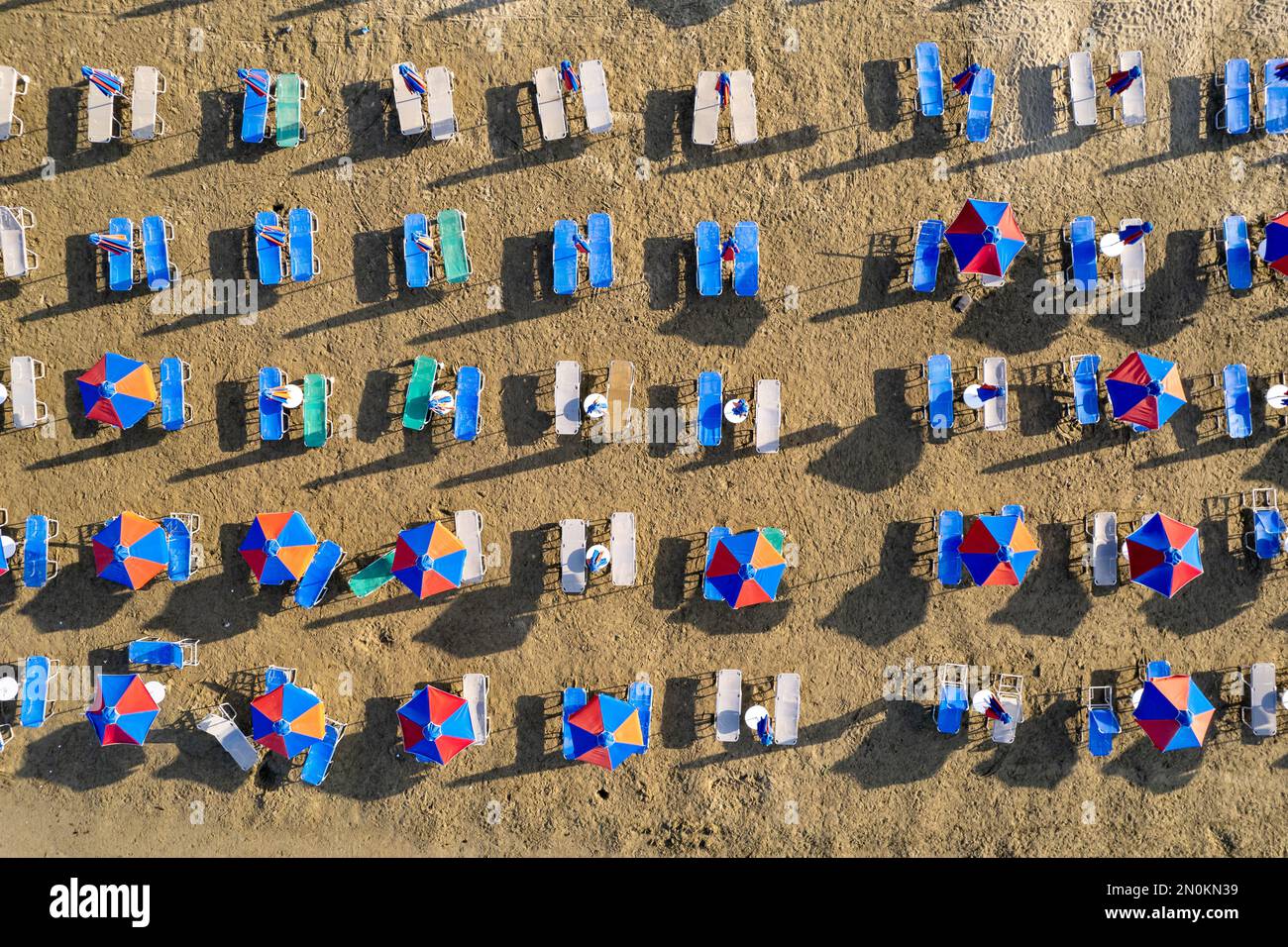 Drone aerial scene of beach umbrellas in a sandy coast. Summer holidays in the sea Stock Photo
