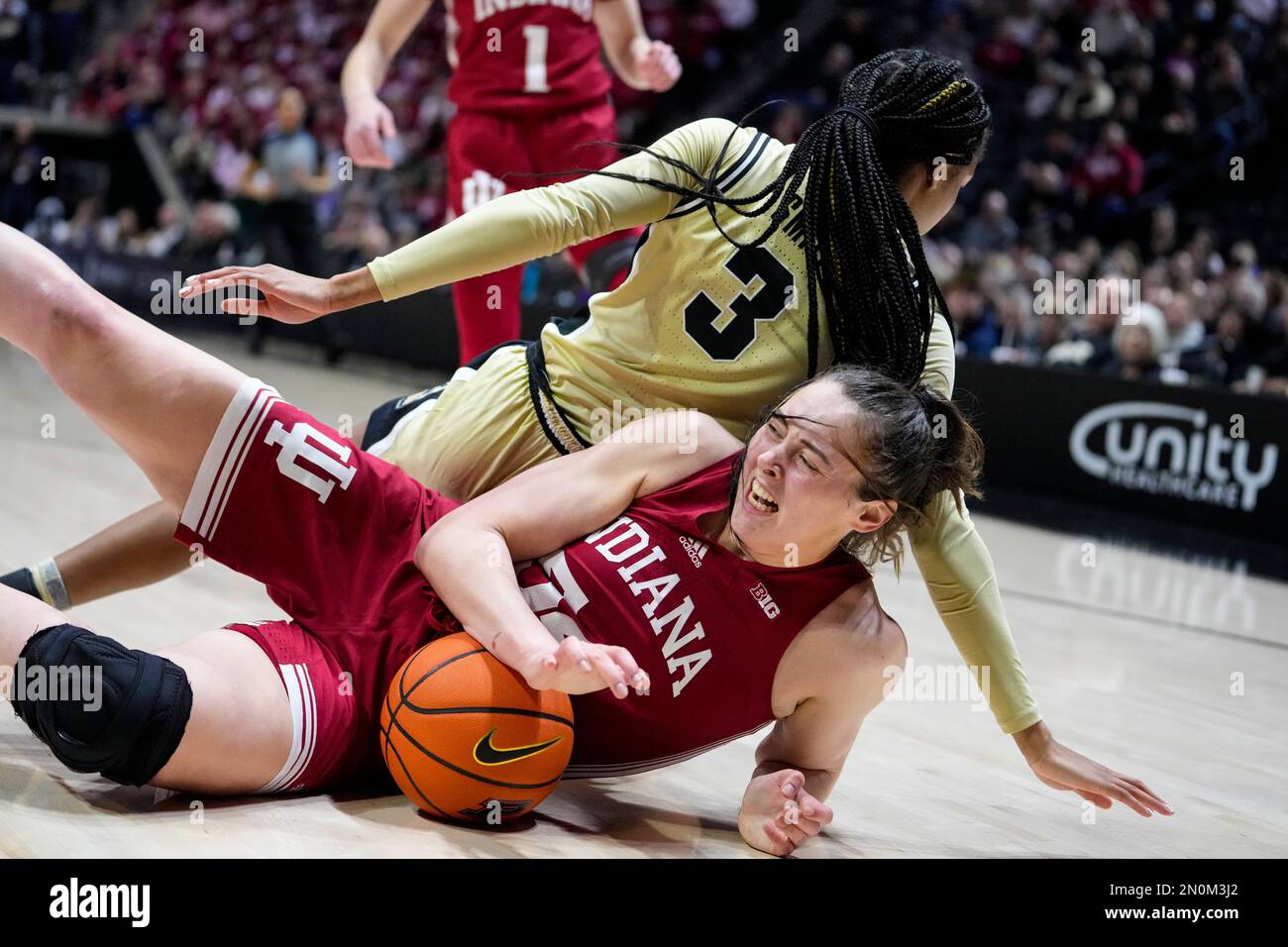 Indiana forward Mackenzie Holmes (54) grabs a loos ball in front of Purdue  guard Jayla Smith (3) in the second half of an NCAA college basketball game  in West Lafayette, Ind., Sunday,
