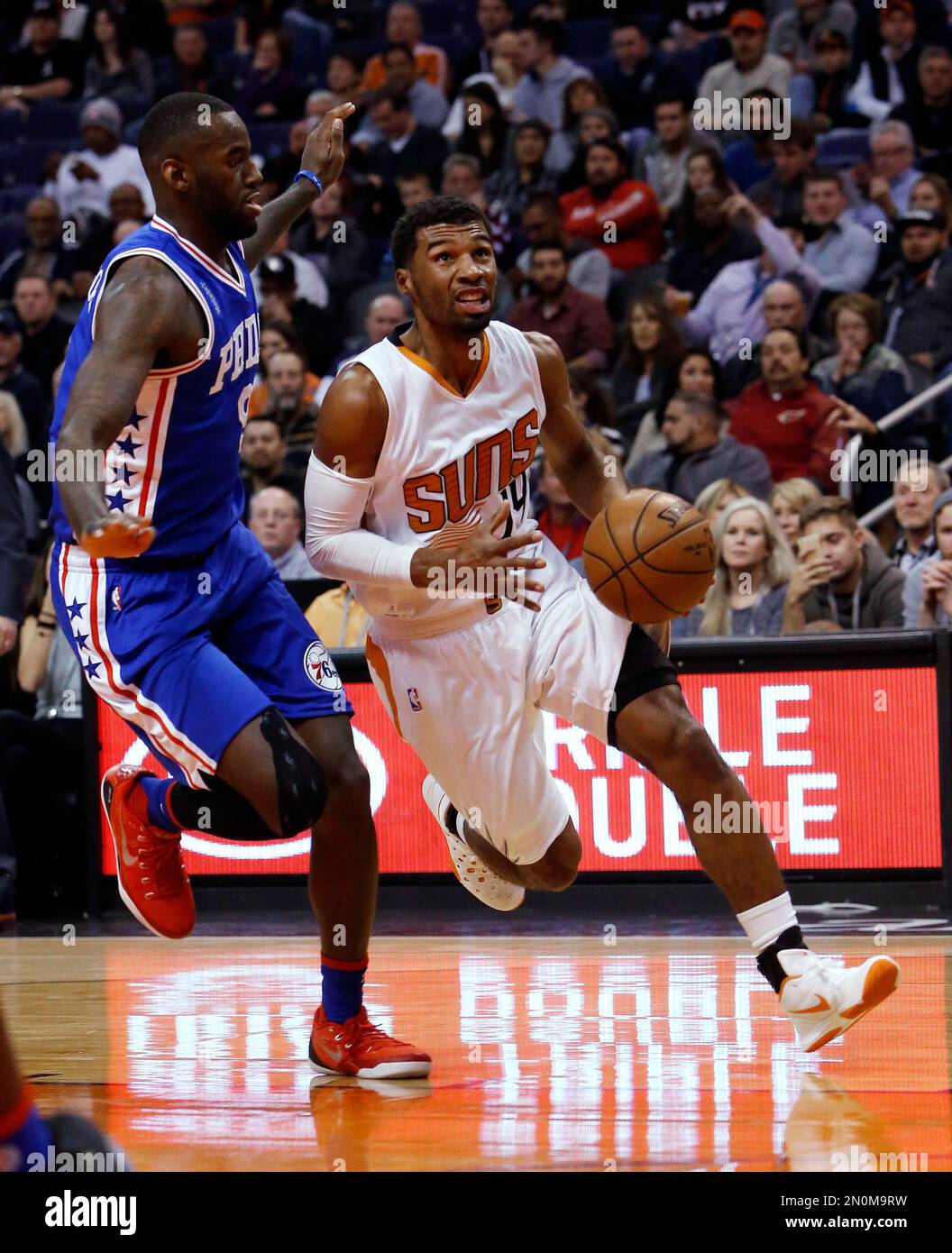 Phoenix Suns guard Ronnie Price, right, drives past Philadelphia 76ers ...