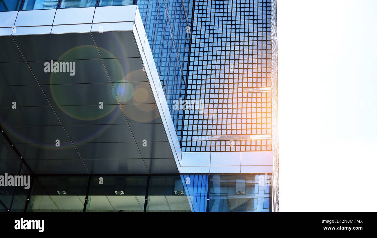 Modern office building with glass facade on a clear sky background ...