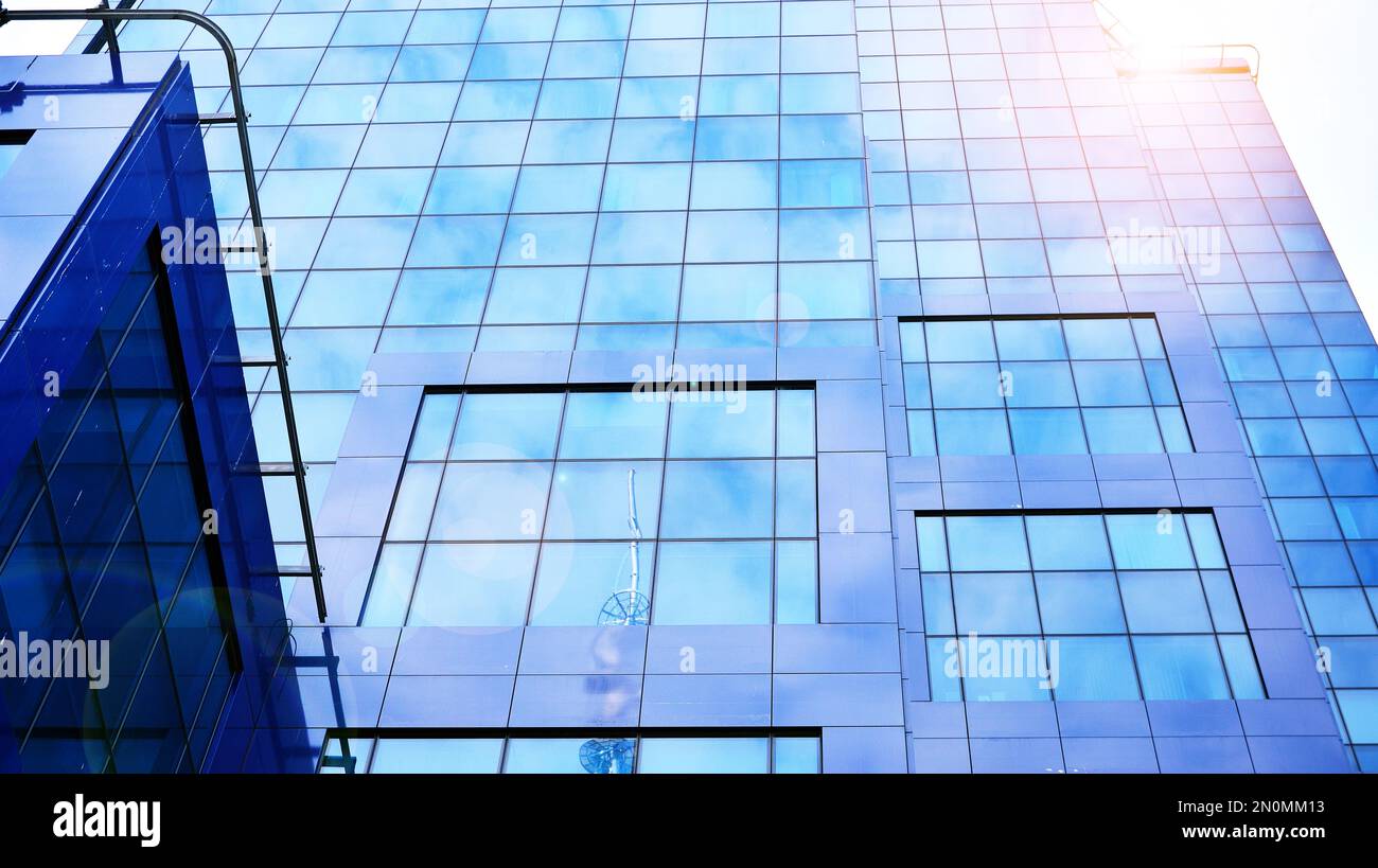 Modern office building with glass facade on a clear sky background ...