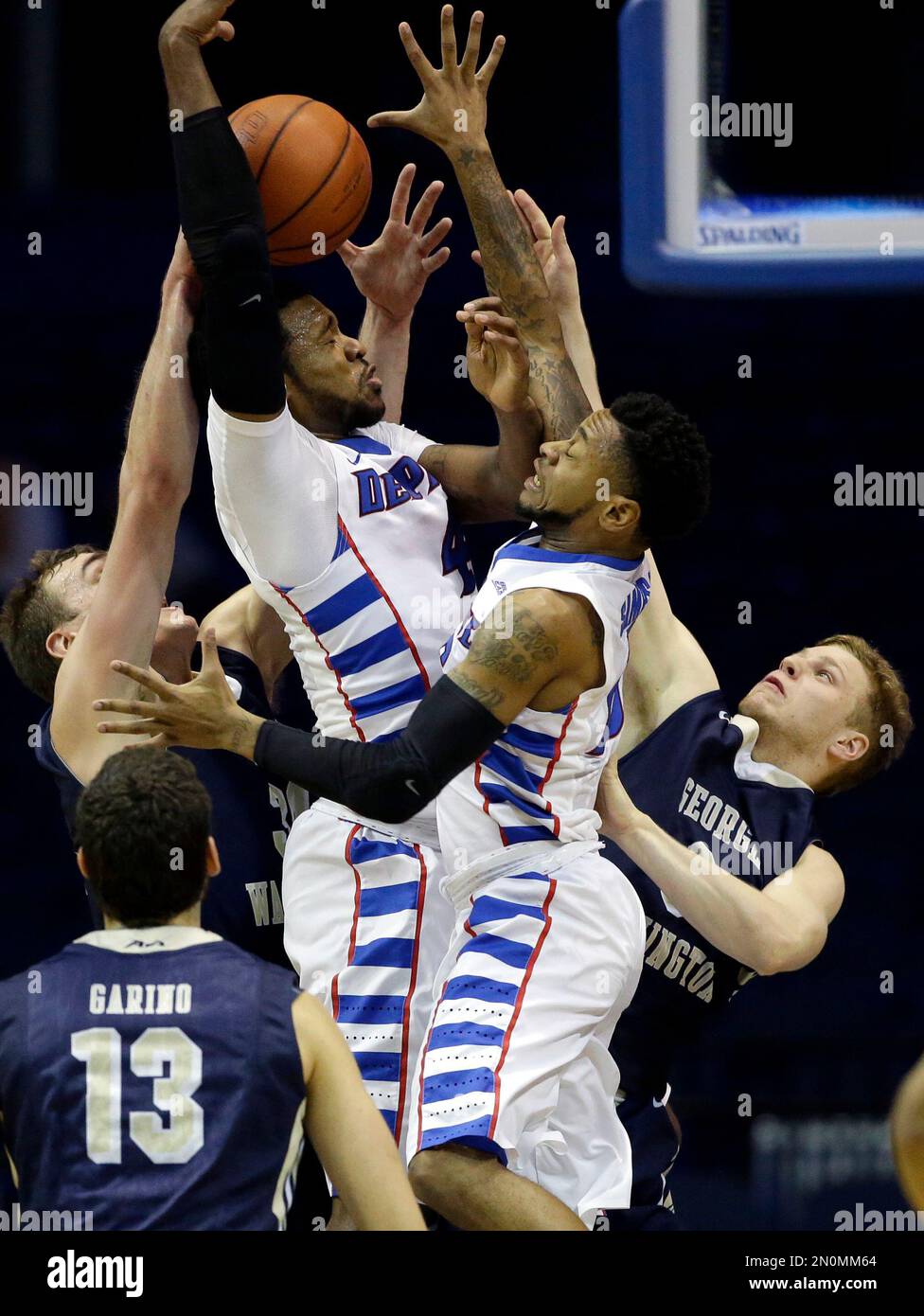 DePaul forward Myke Henry, second from left, guard Aaron Simpson, second  from right, battle for a rebound against George Washington forward Tyler  Cavanaugh, left, and guard Paul Jorgensen during the first half