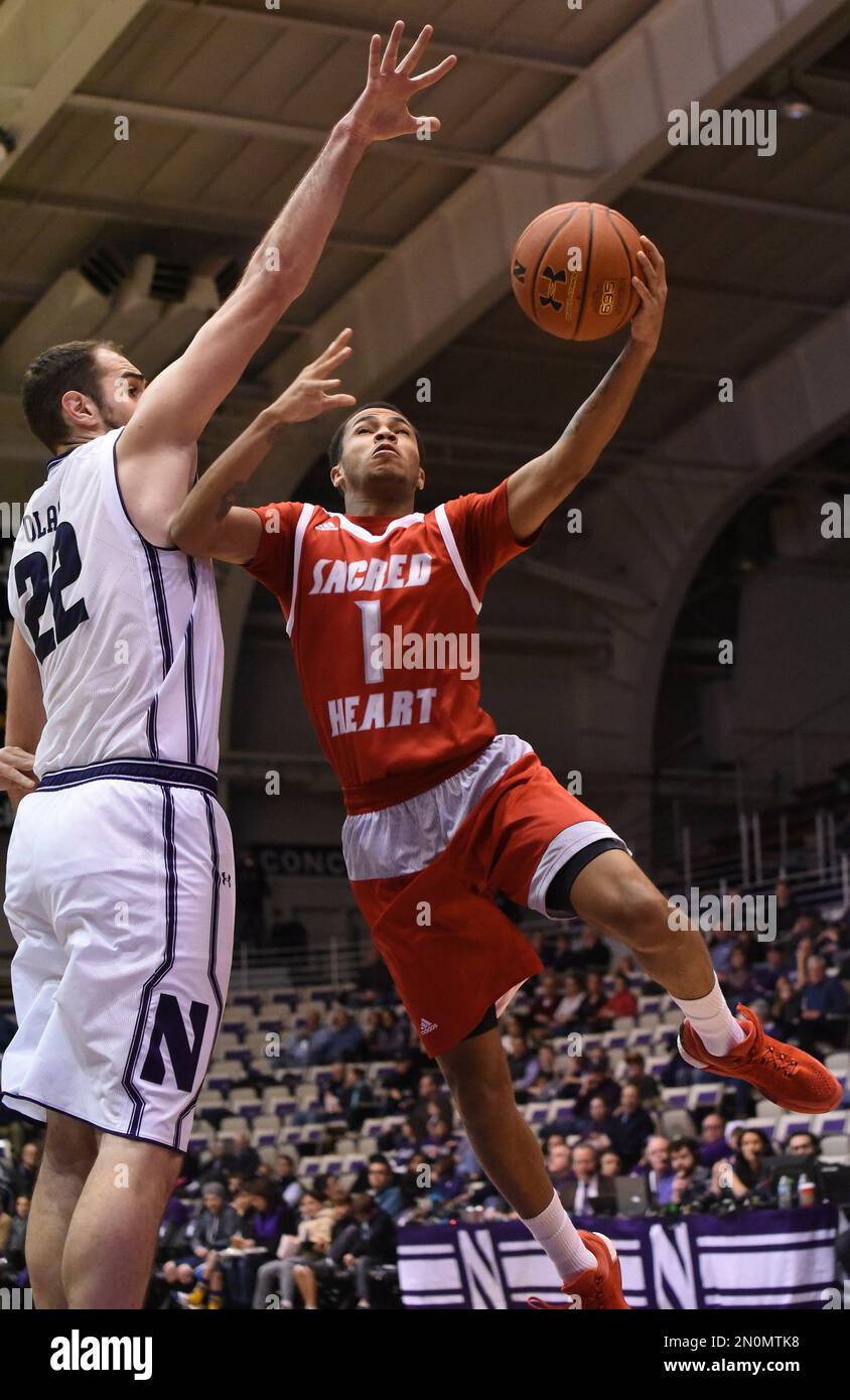 Sacred Heart guard Cane Broome (1) is defended by Northwestern center
