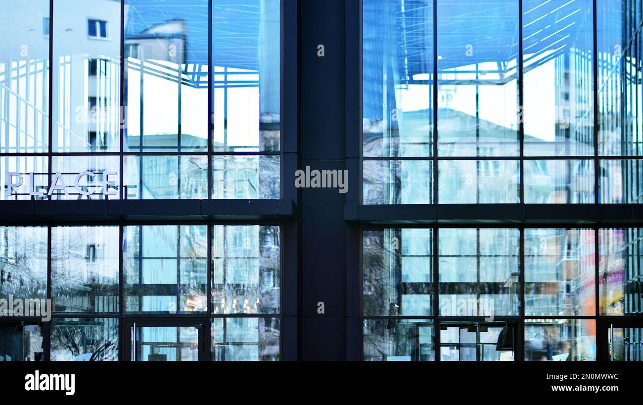 Blue sky and clouds reflected in windows of modern office building ...