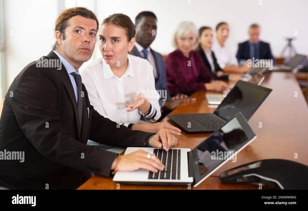 Two professional white male and female colleagues discussing business ...