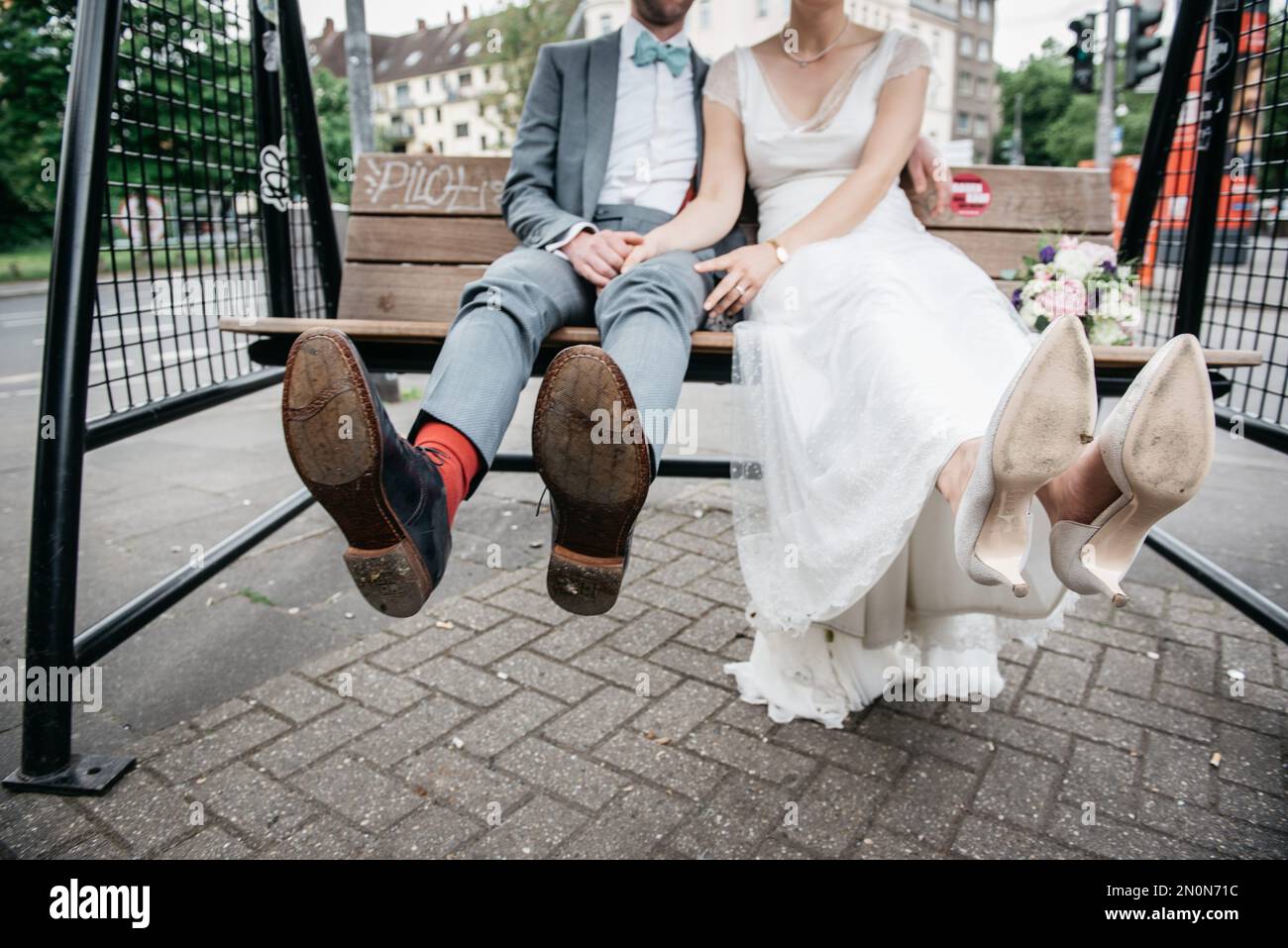 The bride and the groom sitting on a swing Stock Photo - Alamy