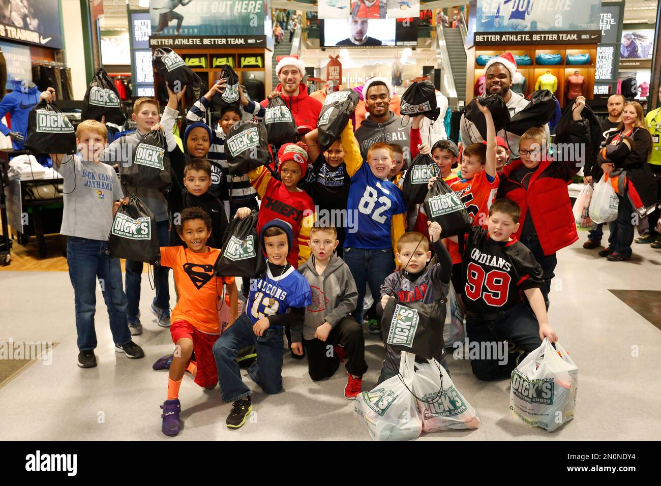IMAGE DISTRIBUTED FOR DICK'S SPORTING GOODS - Kansas City Chiefs players,  Travis Kelce, Charcandrick West and Dontari Poe take a photo with members  of the Football and Cheerleading Club of Johnson County