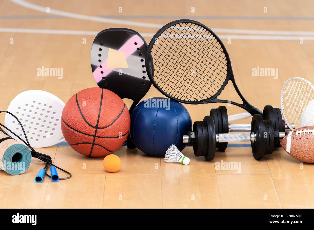 Sports equipment, rackets and balls on hardwood court floor with. Horizontal education and sport poster, greeting cards, headers, website Stock Photo