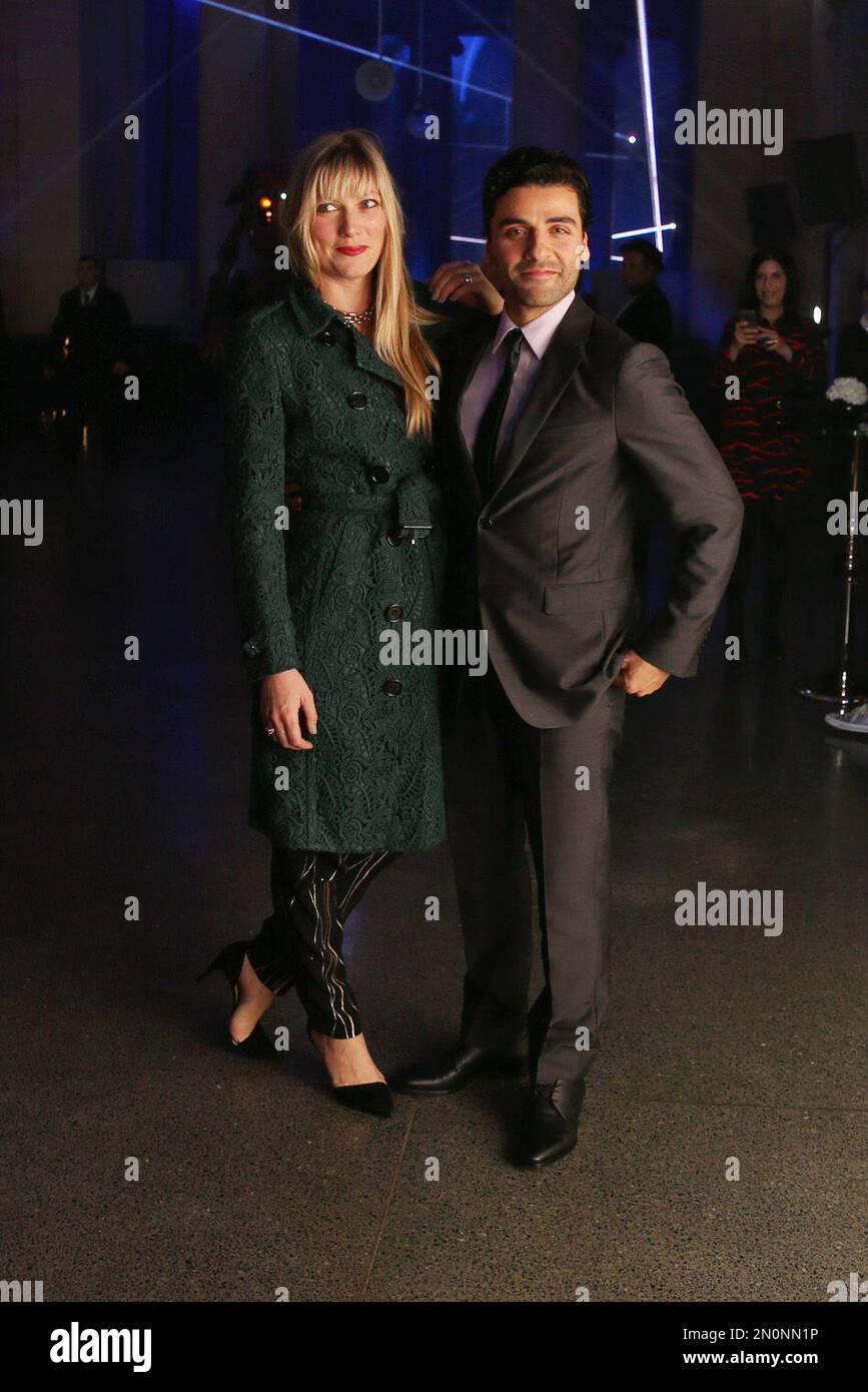 Oscar Isaac right and Maria Miranda pose for photographers upon