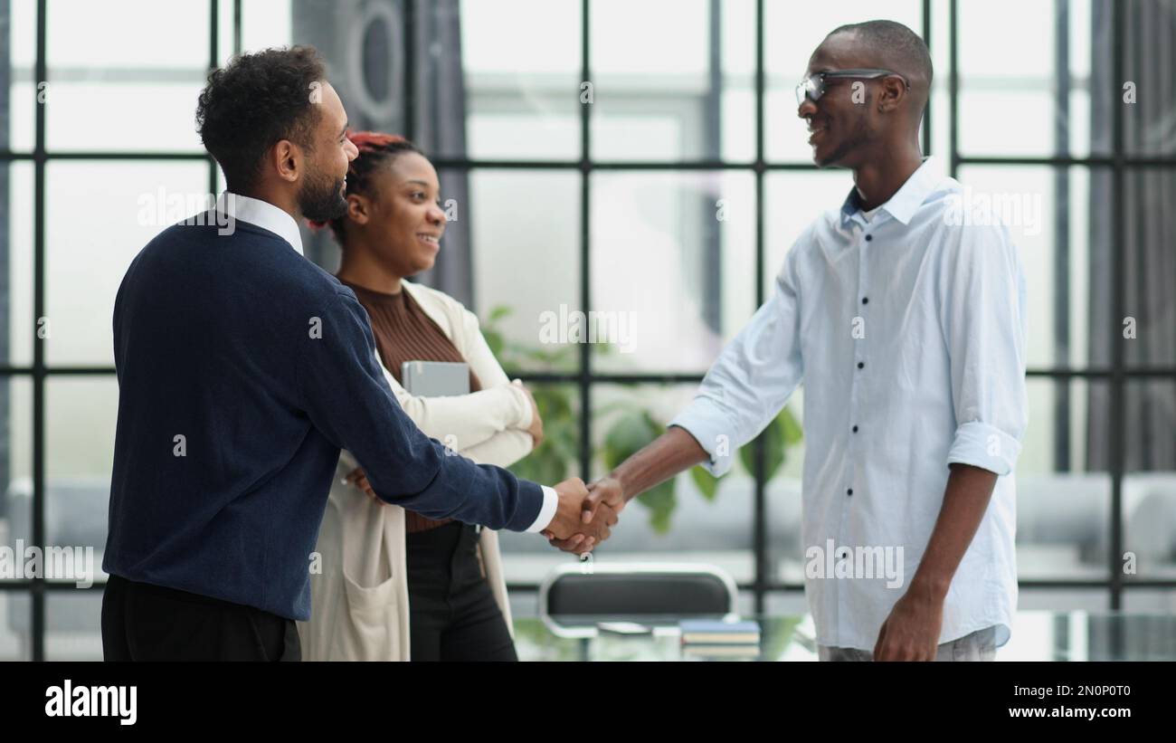 Business team in an office smiling at the camera Stock Photo - Alamy