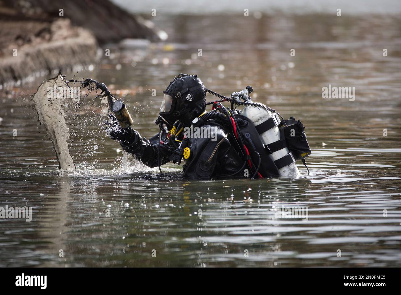 A member of the FBI dive team searches Seccombe Lake, Friday, Dec 