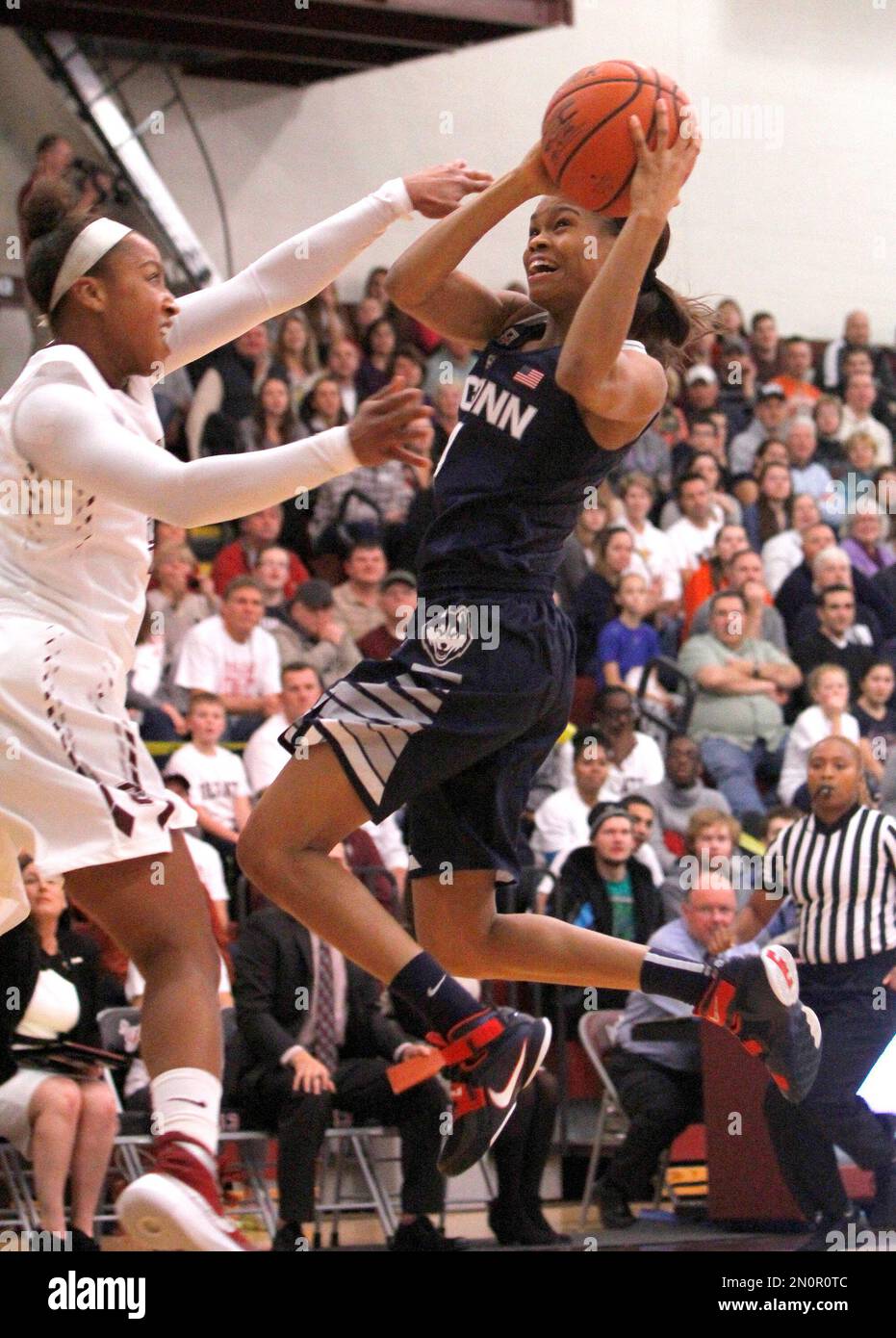 Connecticut’s Moriah Jefferson, right, shoots against Colgate’s Randyll