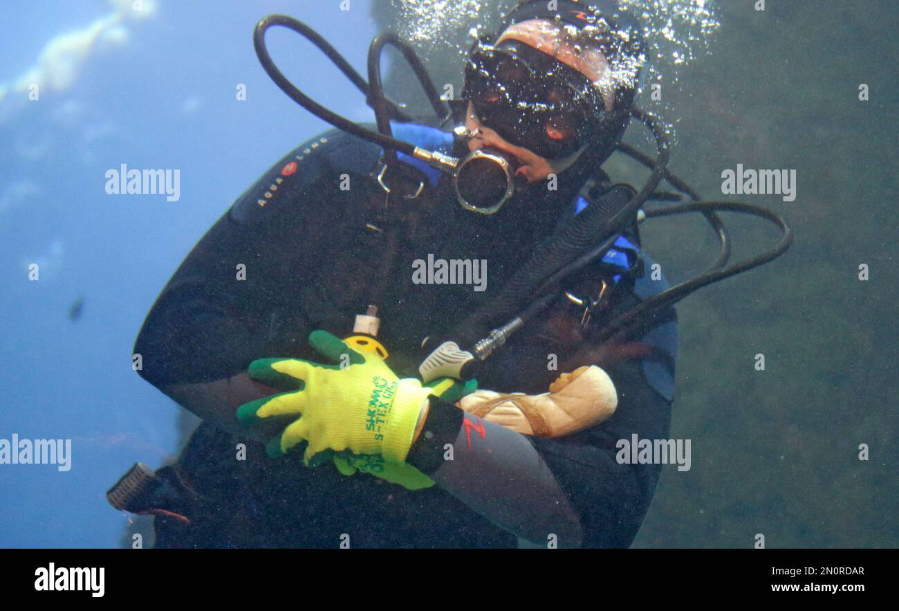 French diver Philippe Morel holds in his arms an Infant Jesus, as he