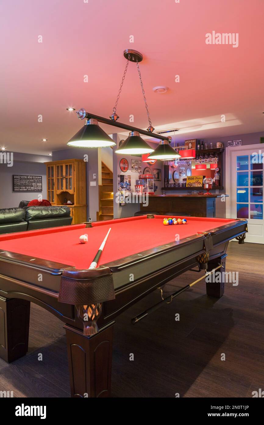 Pool table and bar in family room in basement inside contemporary country style home. Stock Photo