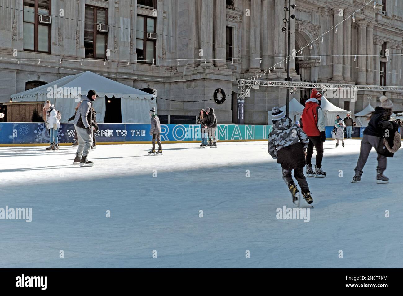 The summer fountains of Dilworth Park in downtown Philadelphia are transformed into the Rothman Orthopaedics ice rink during winter. Stock Photo