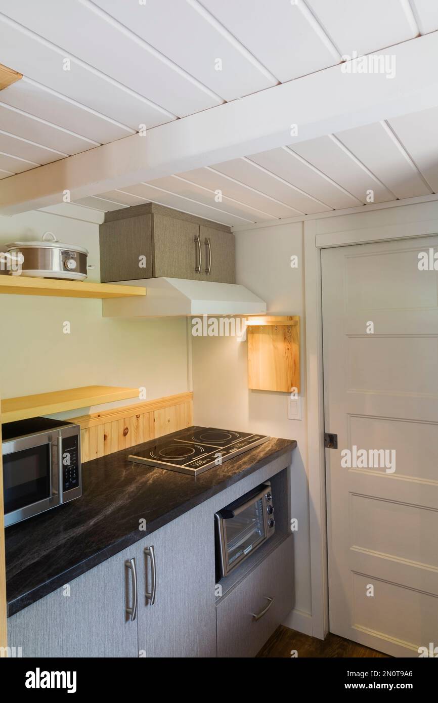 White bathroom door and black arborite kitchen countertop with compact