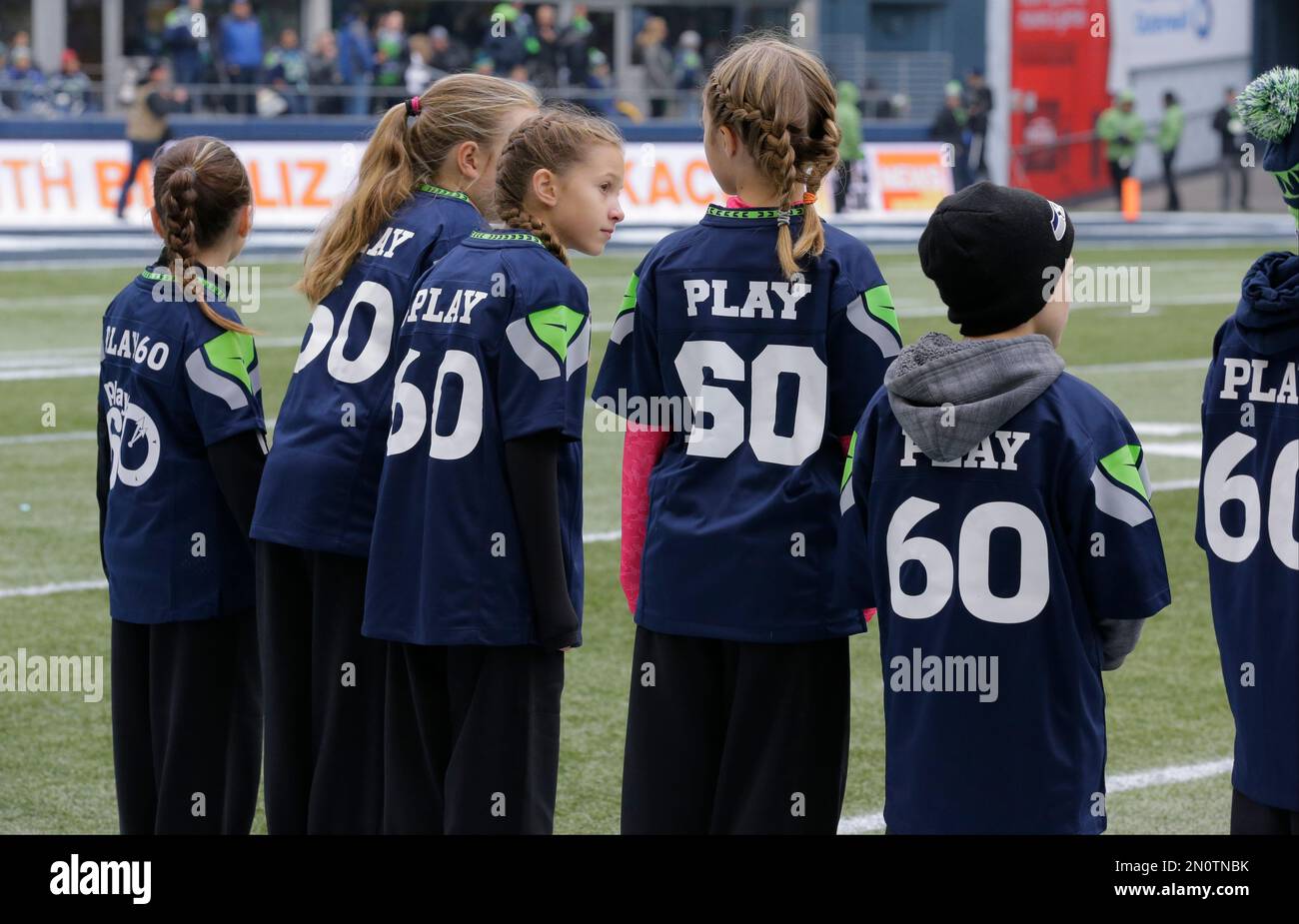 Children wearing NFL football Play60 jerseys wait on the field during  ceremony before an NFL football game between the Seattle Seahawks and the  Pittsburgh Steelers, Sunday, Nov. 29, 2015, in Seattle. (AP