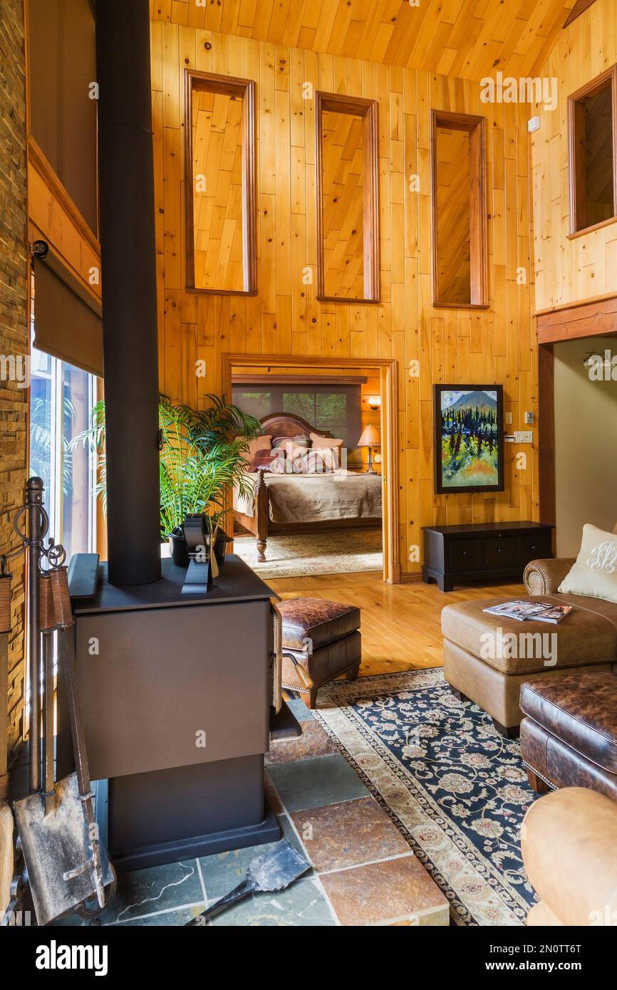 Tan leather sectional sofa and wood burning fireplace in living room