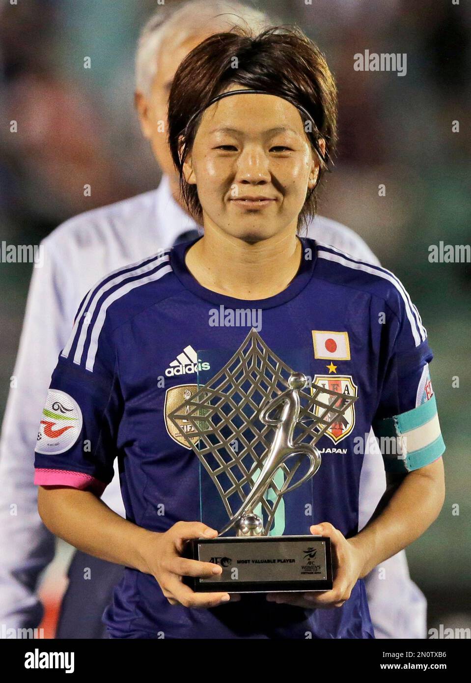 FILE - In this May 25, 2014 file picture Japanese team's captain Aya Miyama  poses with the trophy for the most valuable player after the AFC Women's  Asian Cup final soccer match, image size:959x1390
