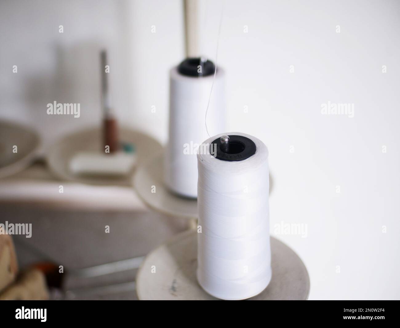 White thread spool hi-res stock photography and images - Alamy