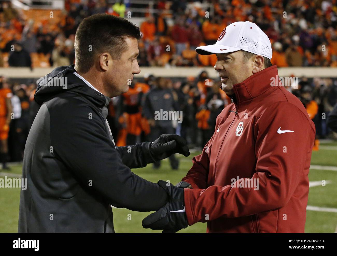 Oklahoma State head coach Mike Gundy, left, and Oklahoma head coach Bob