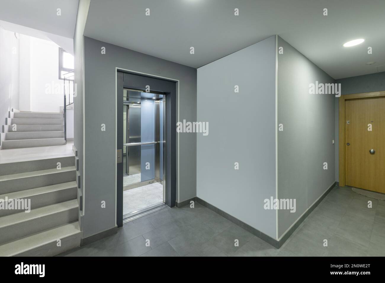 Interior elevator of a modern apartment building clad in mirror panels