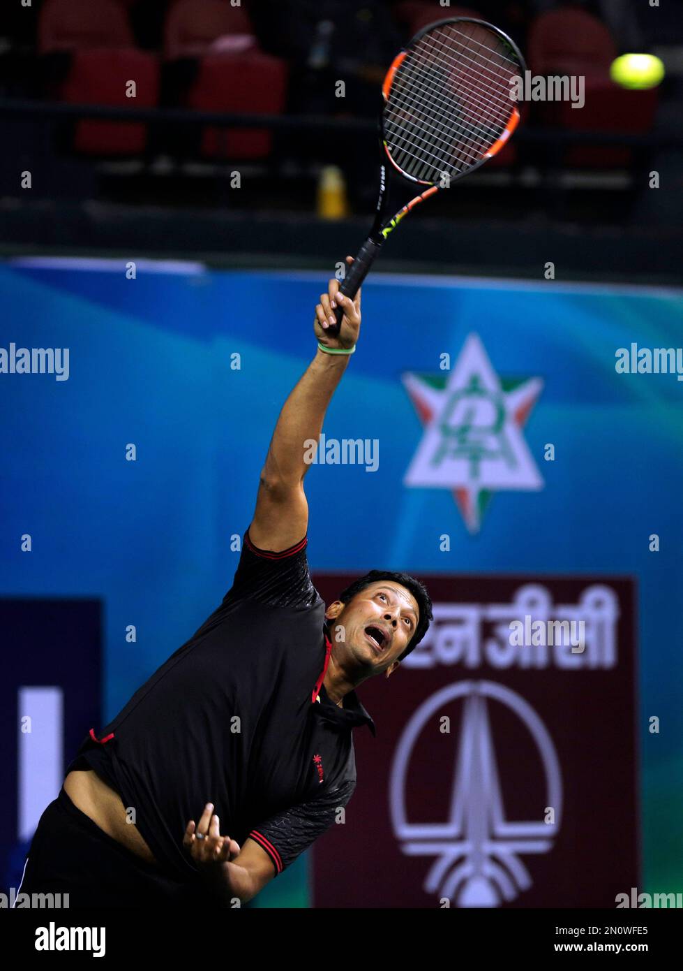Indian tennis player Mahesh Bhupathi serves during an exhibition mixed  doubles match against Martina Navratilova and Leander Paes to promote International  Premier Tennis League (IPTL) in New Delhi, India, Friday, Nov. 27,