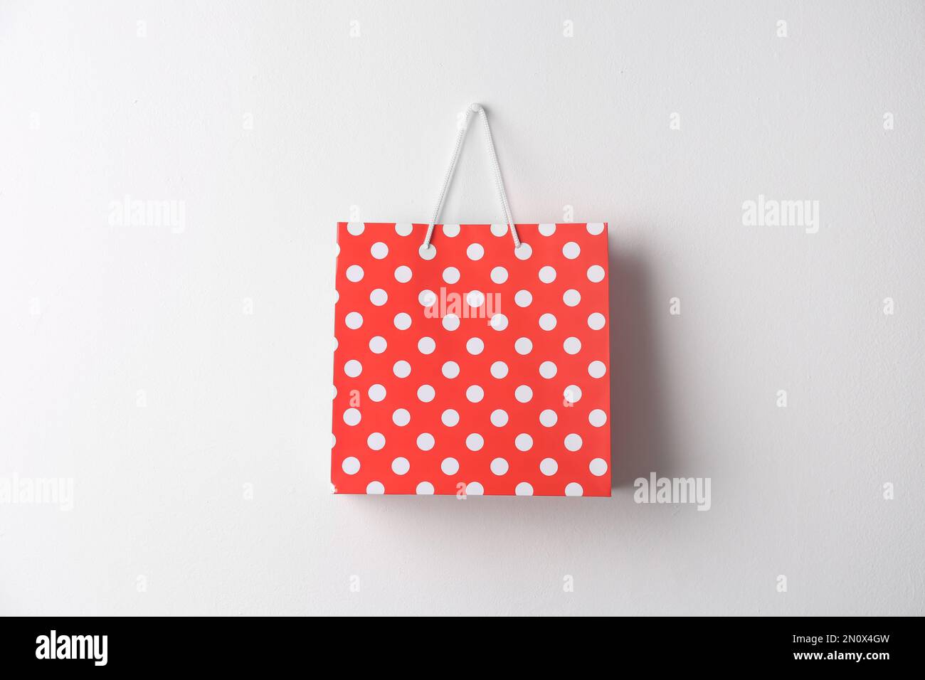 Paper shopping bag hanging on white wall Stock Photo Alamy
