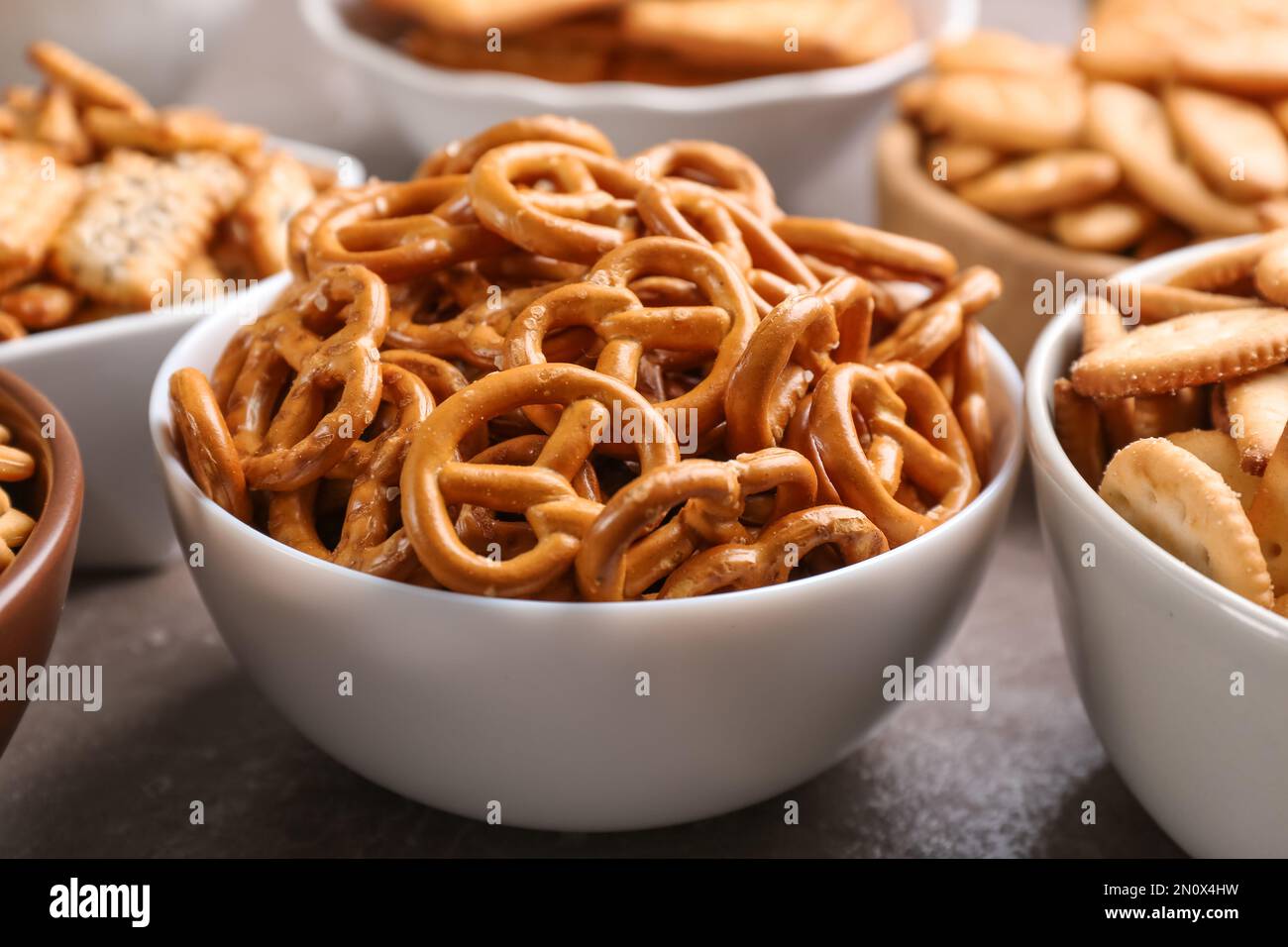 Delicious crackers in bowls on table, closeup Stock Photo