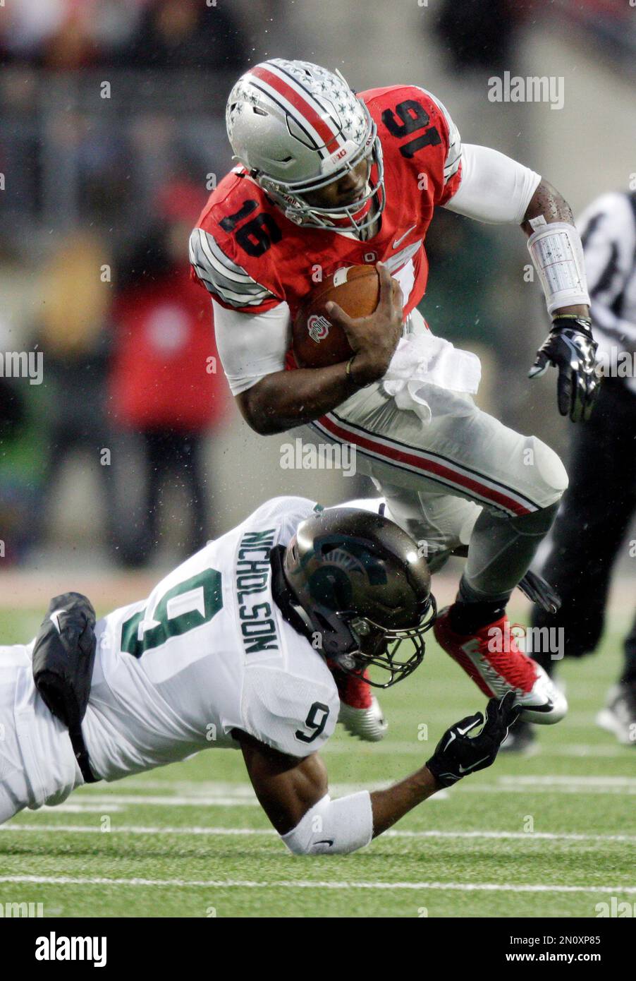 Michigan State safety Montae Nicholson, left, tackles Ohio State running back Ezekiel Elliott