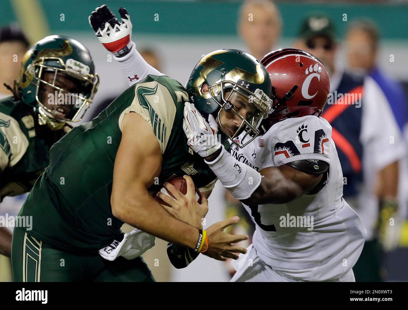 South Florida quarterback Steven Bench (2) slips a tackle by Cincinnati ...