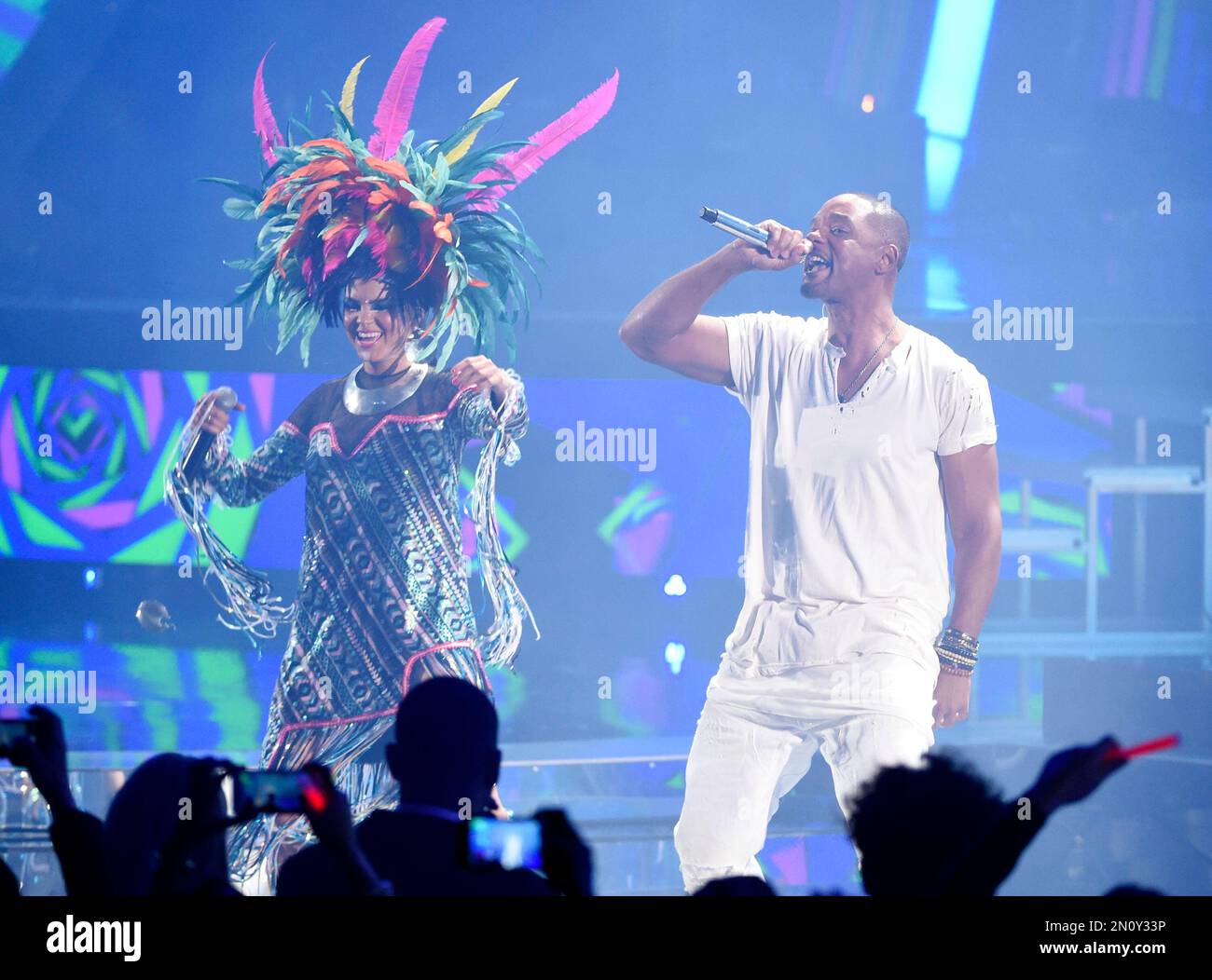 Liliana Saumet, left, of Bomba Estereo, and Will Smith perform "Fiesta