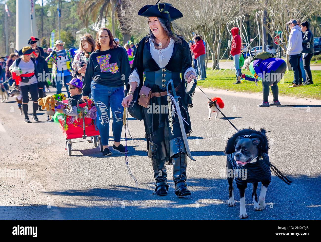 Pet owners and their dogs participate in the Mystic Krewe of Salty Paws