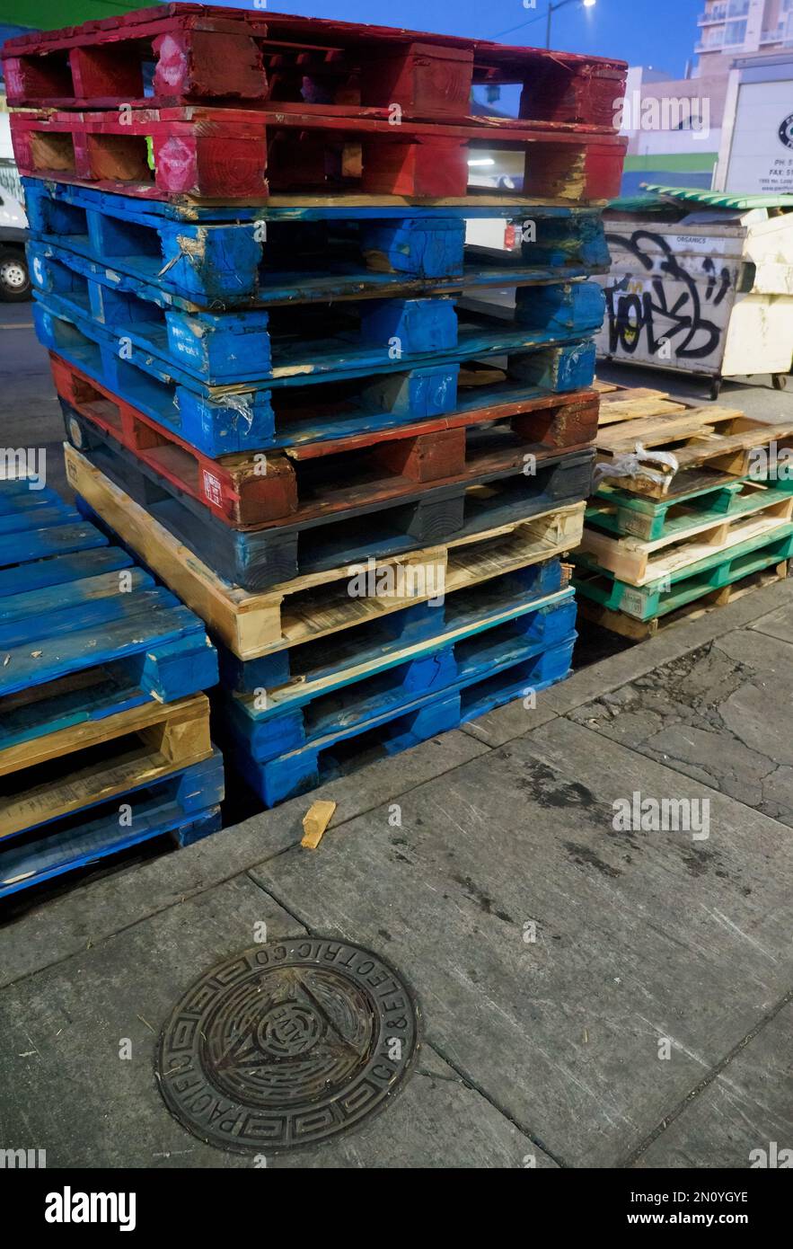 Stack of blue and red and green shipping pallets ready for cargo Stock Photo