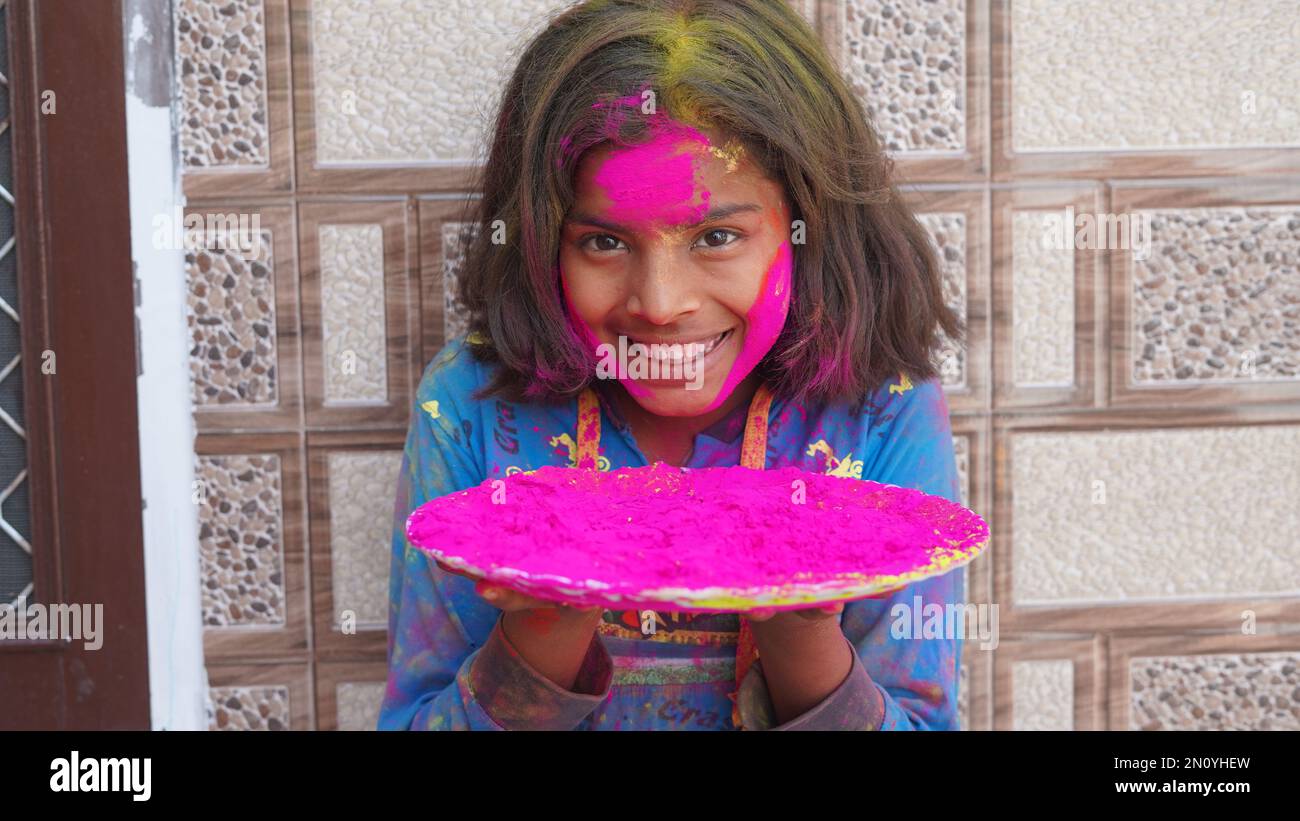 Attractive girl in pink colors Holi. Holi facial shot on spring color ...