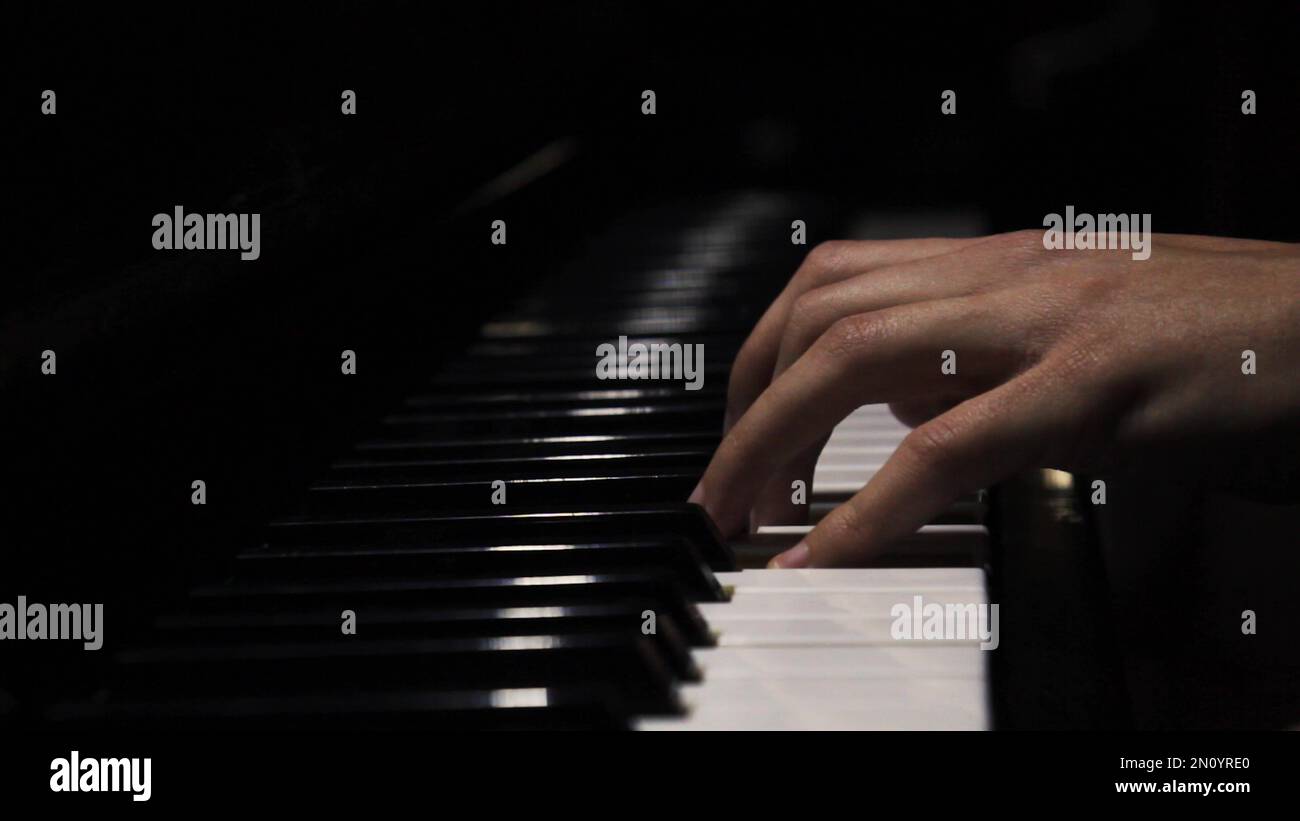 Piano keys close up in dark colors. Student trains to play the piano