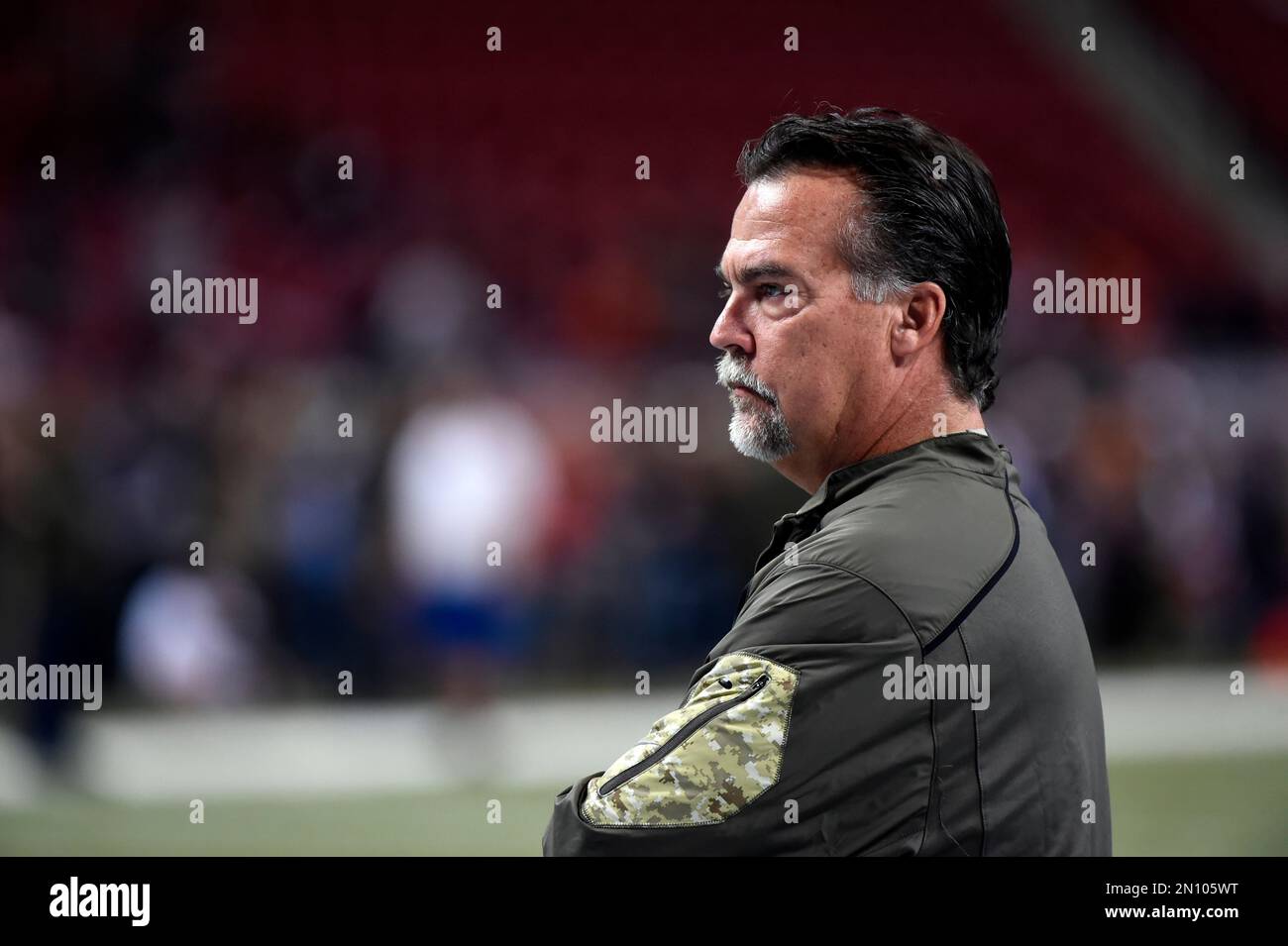 St. Louis Rams head coach Jeff Fisher watches his team warm up before ...