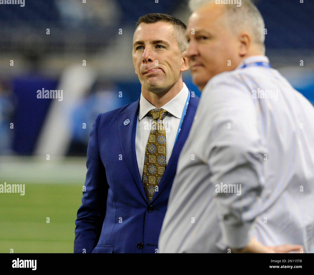 Detroit Lions President Tom Lewand, left, watches his team warm up