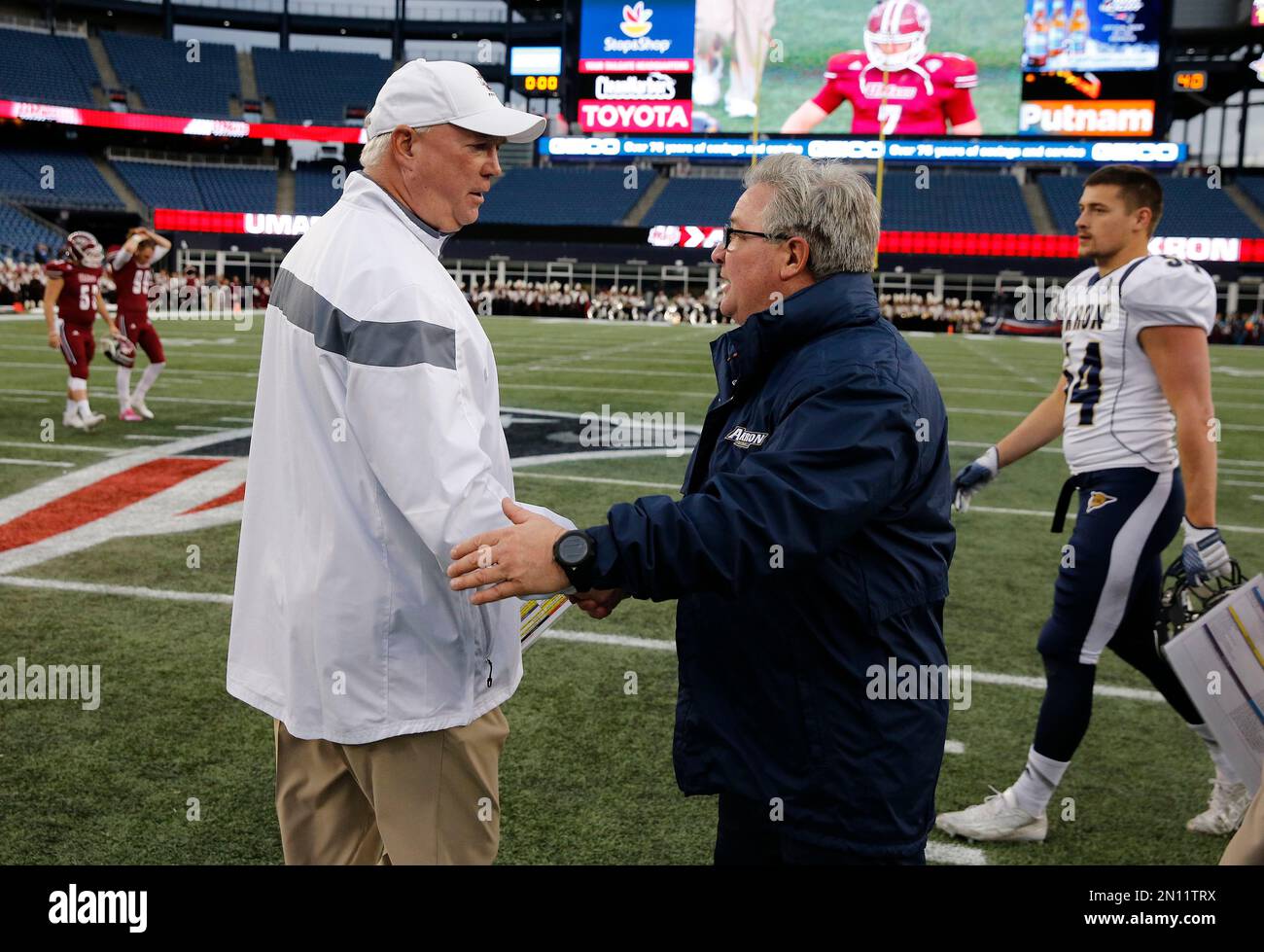 Massachusetts head coach Mark Whipple, left, and Akron head coach Terry