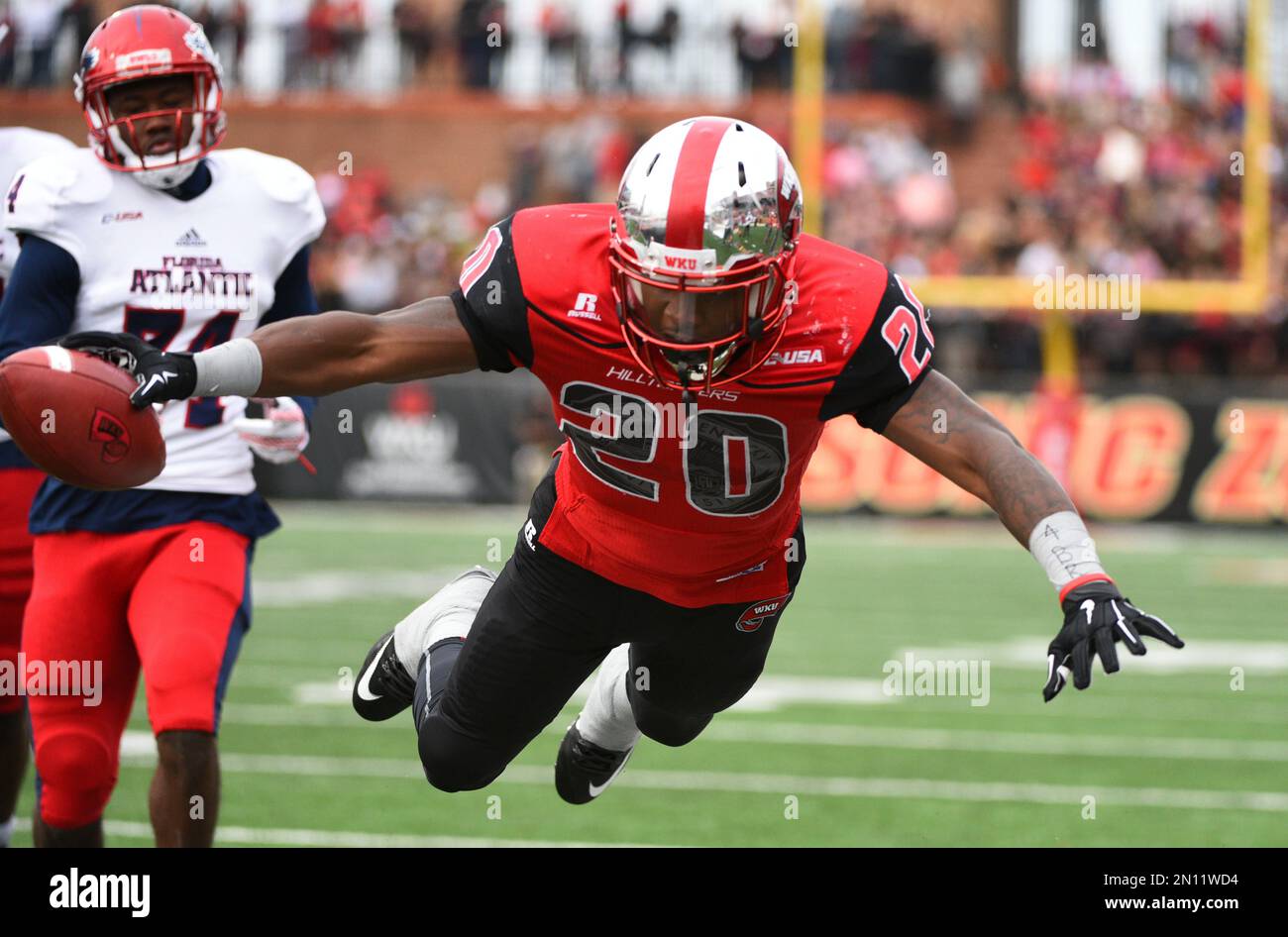 Western Kentucky running back Anthony Wales (20) dives into the end ...