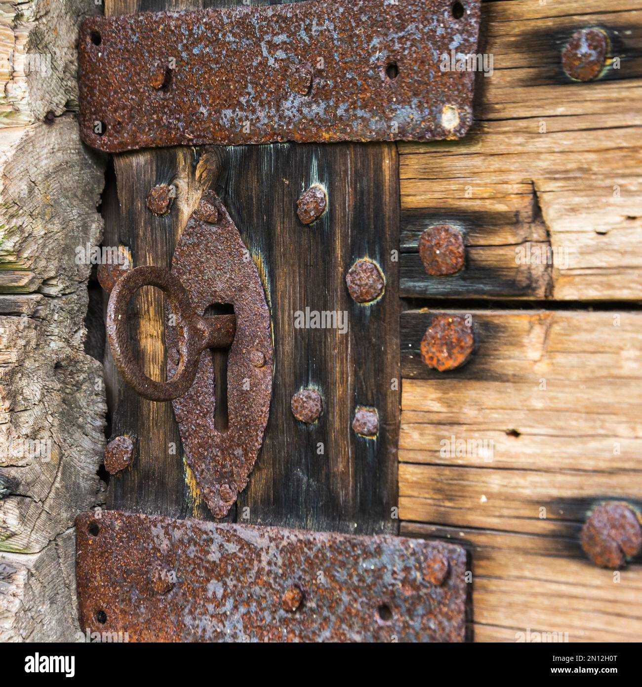 Old rusty barn door lock with a key Stock Photo