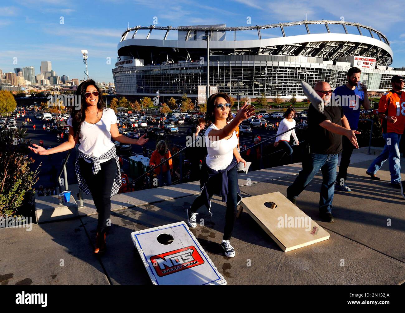 Alexis Perry tosses a bean bag with Laila Aydi prior to an NFL football