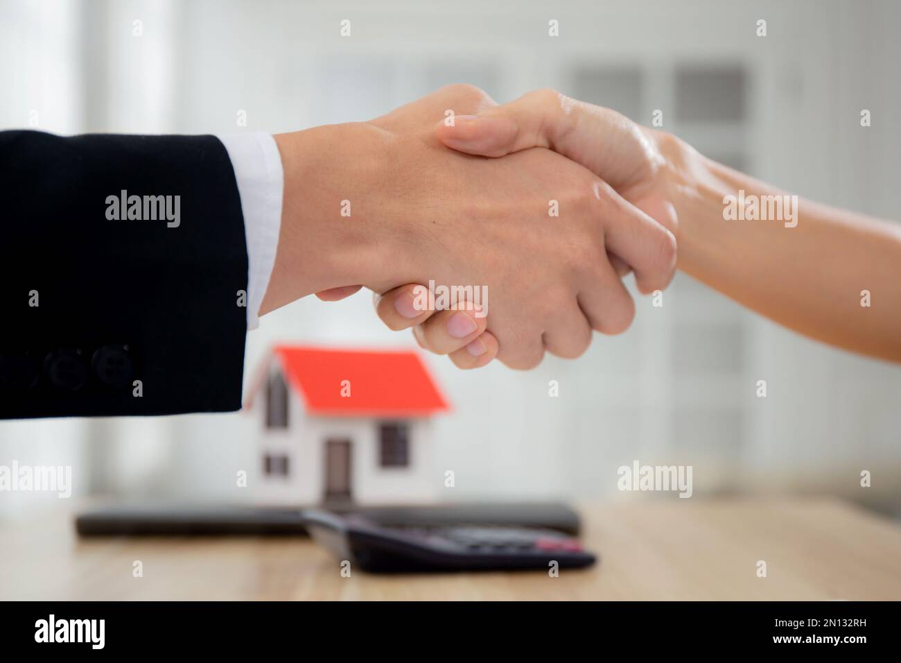 Closeup hands of real estate agent and customer handshake together ...