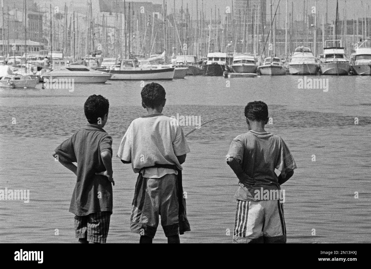 Boys fishing, Old Port, Marseille, 28. 08. 91, Département Bouches-du-Rhône, Region Provence-Alpes-Côte d'Azur, France, Europe Stock Photo