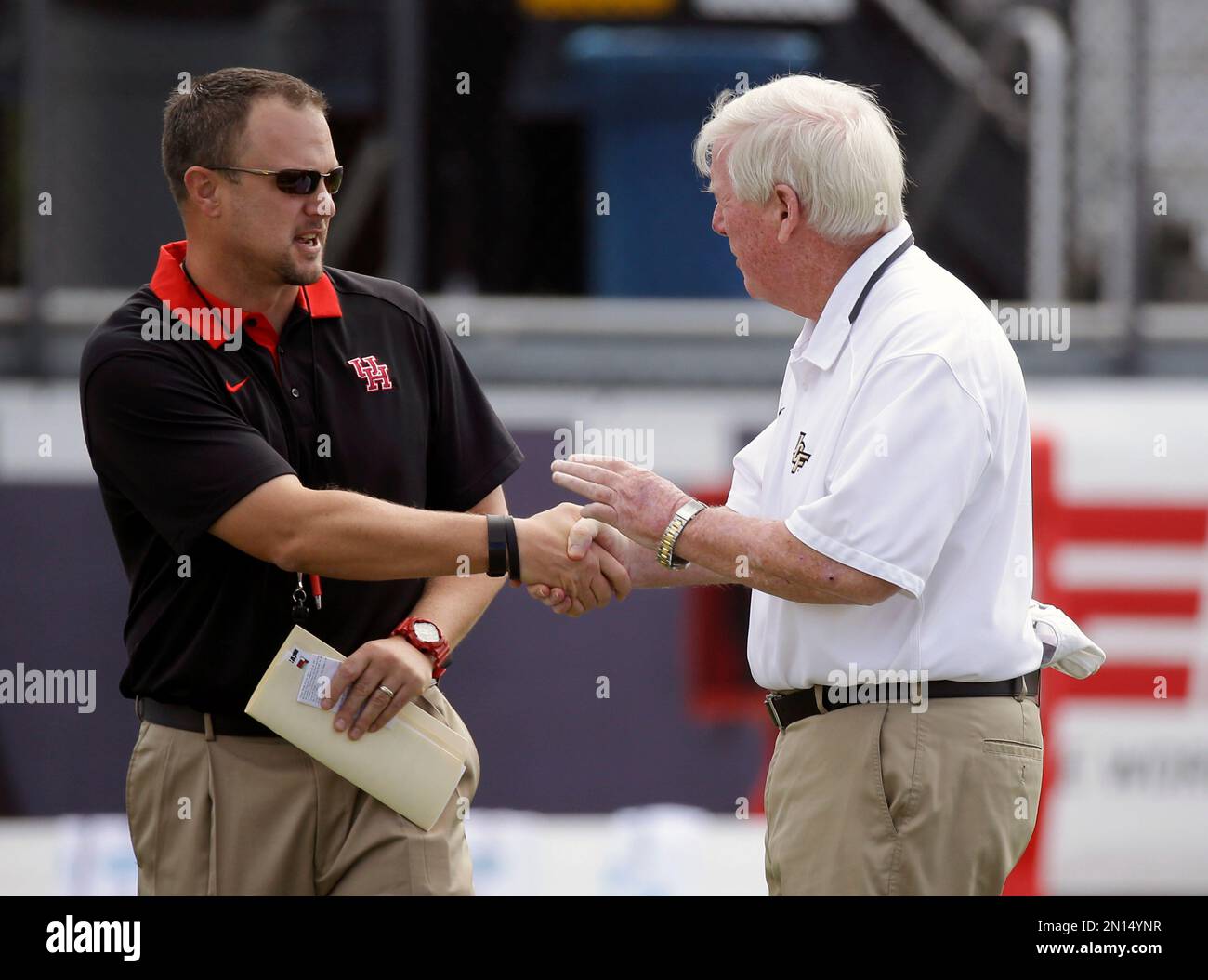 Houston head coach Tom Herman, left, and Central Florida head coach