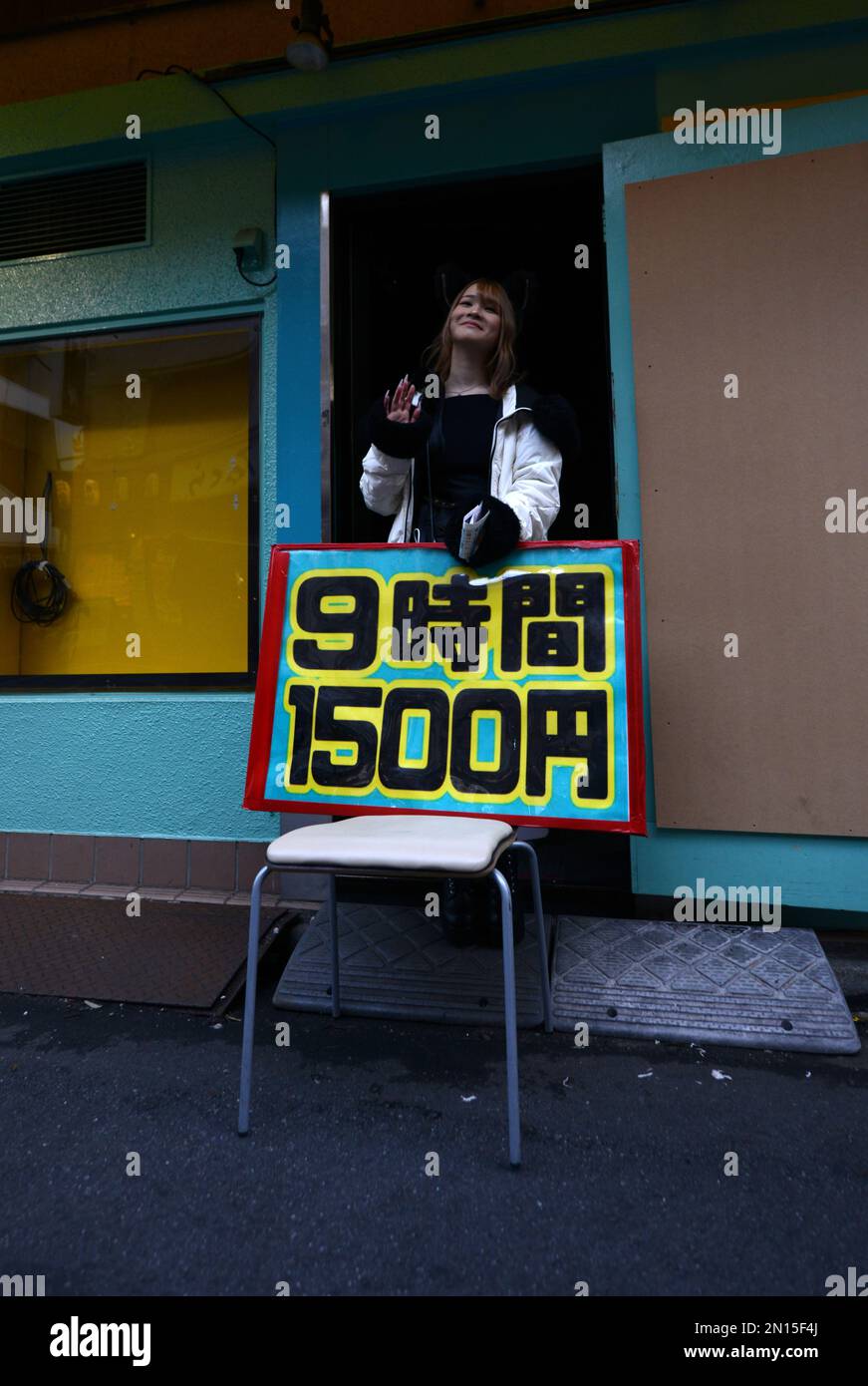 Girls dressed in French maid costumes handing out discount coupons for